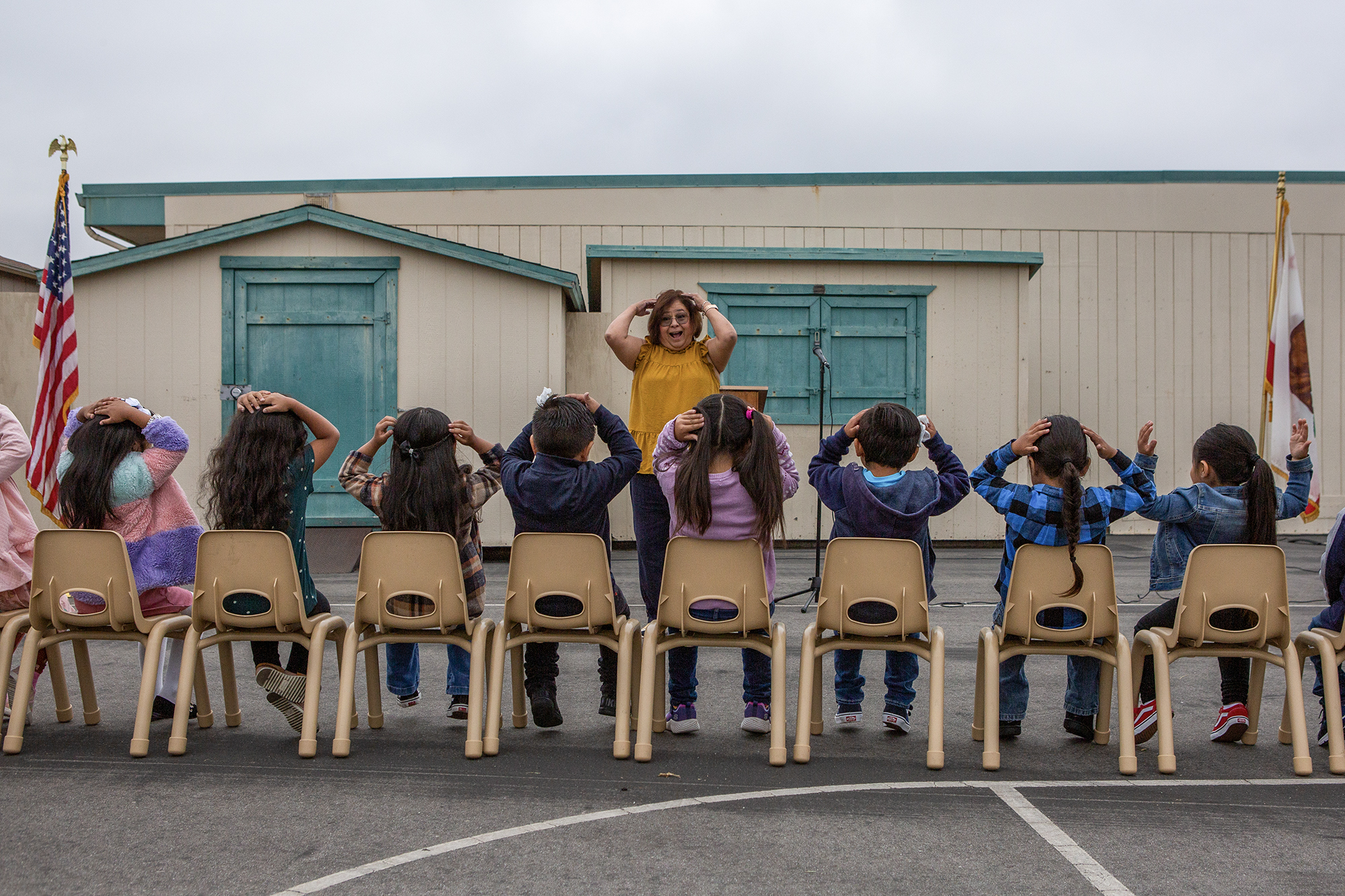 A teacher plays a game with students before an assembly on the first day of school at Loma Vista Elementary School in Salinas on Aug. 8, 2023. Photo by Semantha Norris, CalMatters