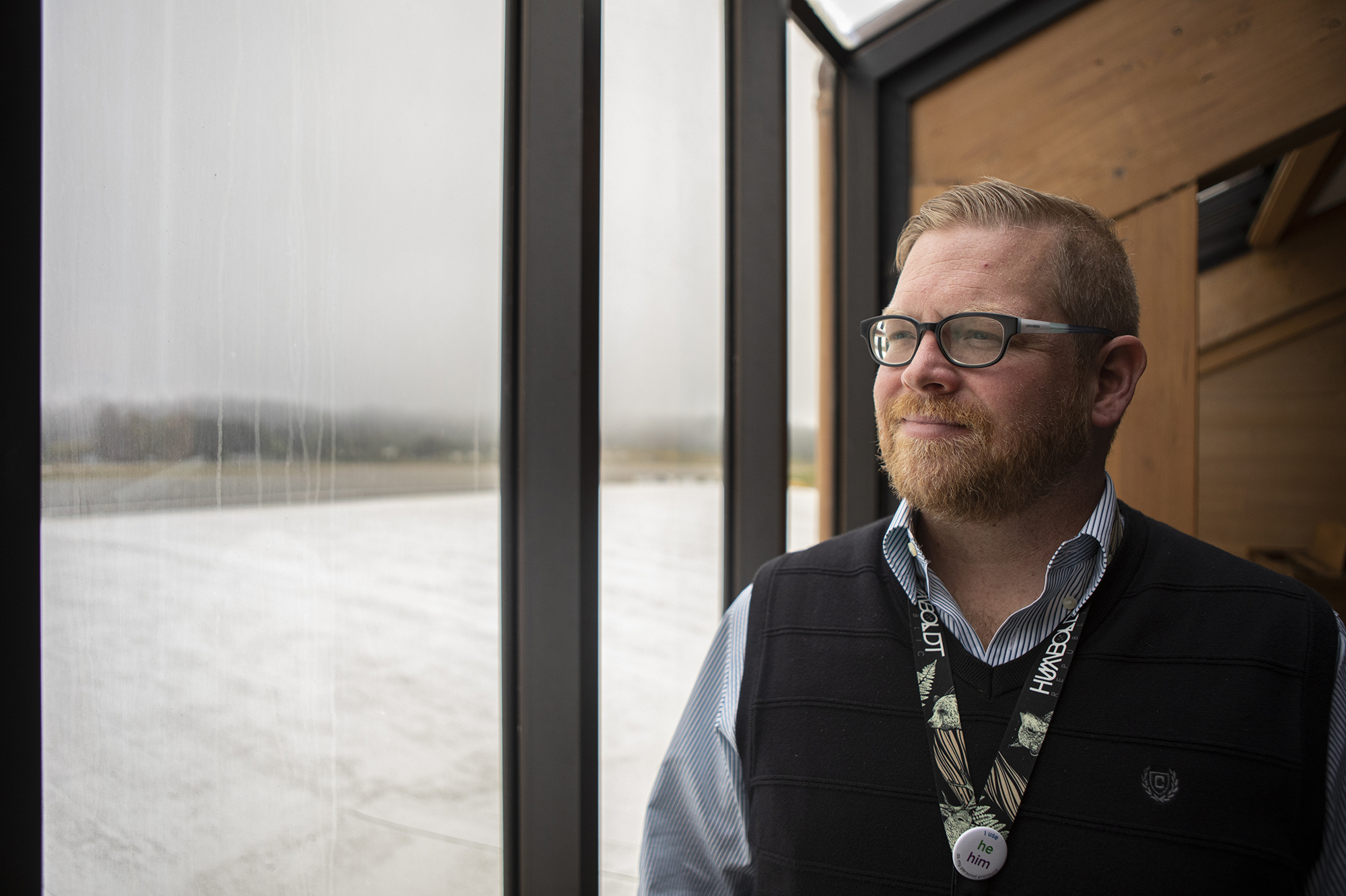 Scott Adair, director of economic development in Humboldt County, stands near the window of the observation deck of the Arcata Eureka Airport on June 6, 2023. Photo by Larry Valenzuela, CalMatters/CatchLight Local