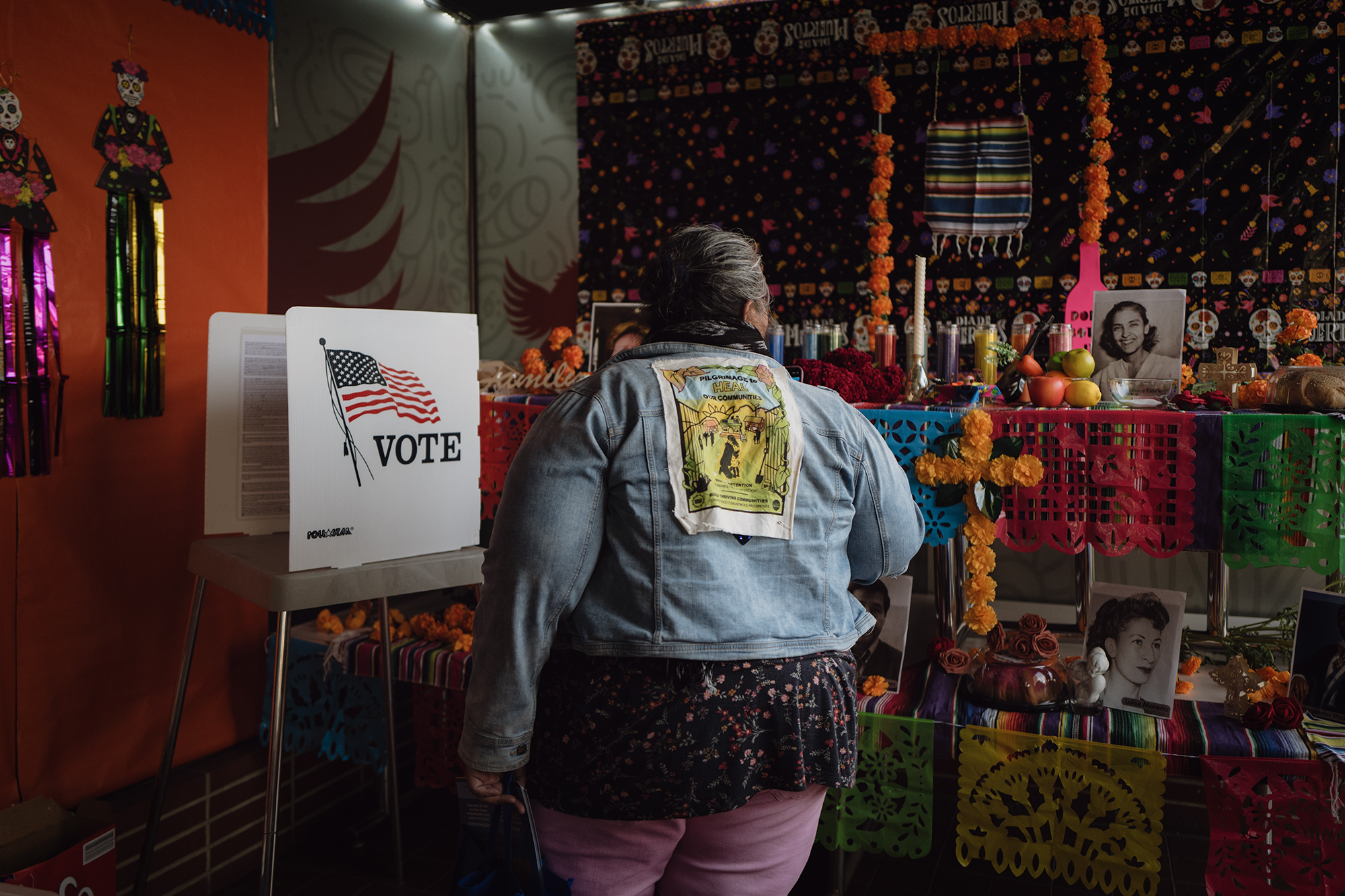 Voting booths in front of an altar for Dias de los Muertos during the Latino Mock Voting event organized by The League of United Latin American Citizens in Tulare on Nov. 1, 2023. Photo by Zaydee Sanchez for CalMatters