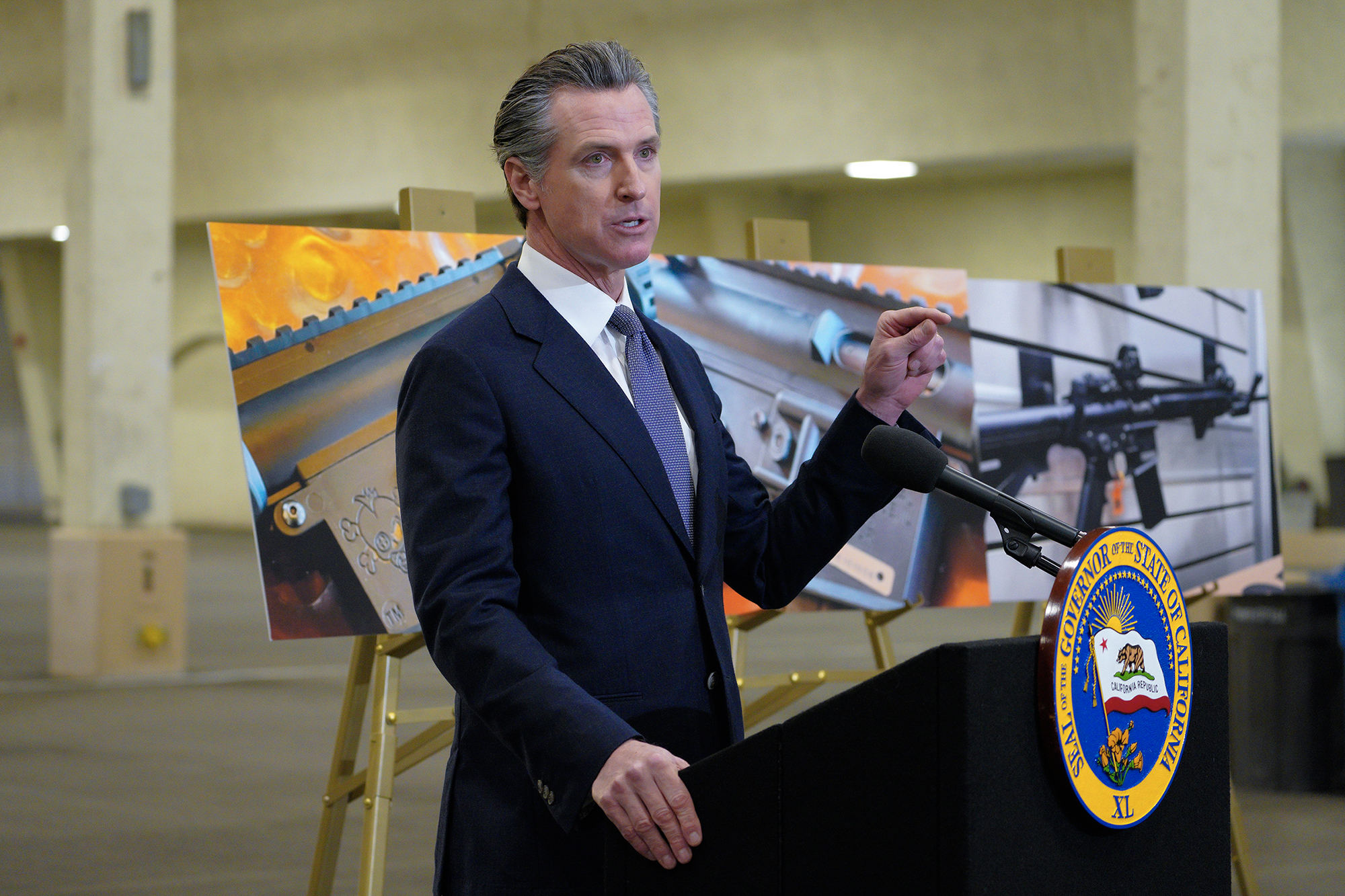 Gov. Gavin Newsom, along with several elected officials, met with the media at Del Mar Fairgrounds in 2022, where he backed state legislation that would allow for private citizens to enforce the state's ban on assault weapons. Photo by Nelvin C. Cepeda, The San Diego Union-Tribune via AP Photo