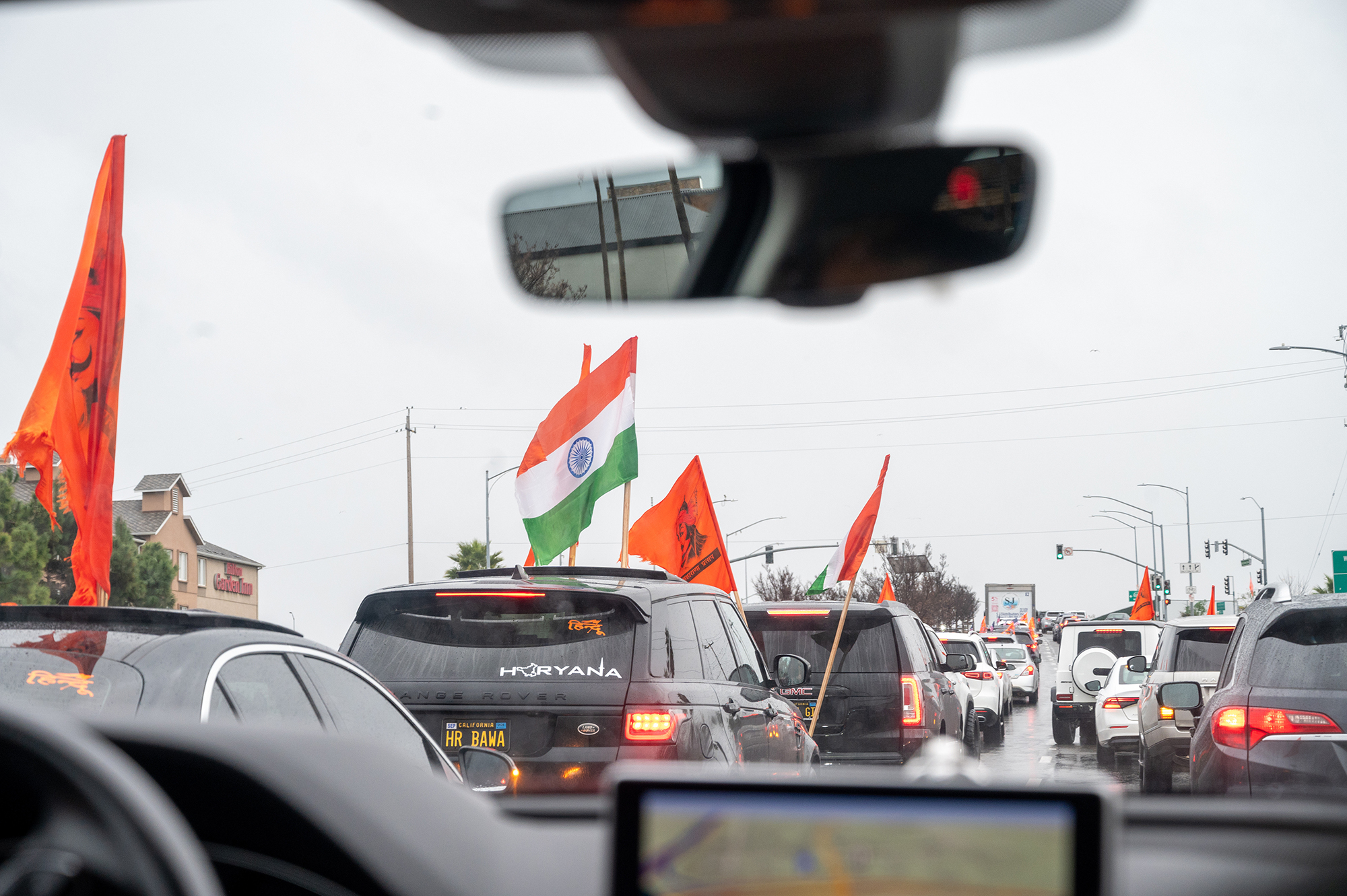 Cars displaying a Lord Ram flag and the Indian flag line up for the freeway on-ramp for the Ram Janmabhoomi Bay Area Car Rally in Sunnyvale, Calif., on Jan. 20, 2024. The car rally was organized by six local volunteers and included over 900 cars, each holding a combination of Lord Ram, India, and USA flags. Photo courtesy of Sree Sripathy