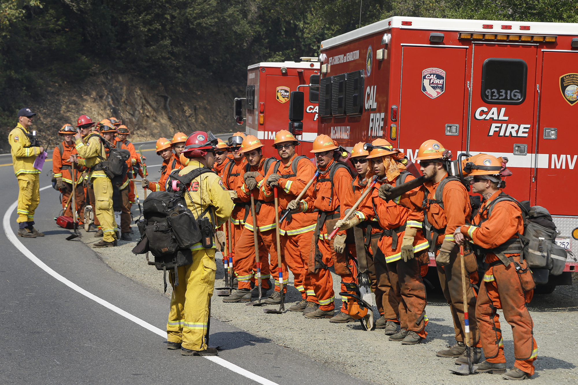 Prisoners from the McCain inmate crew from San Diego, prepare to clear brush from a road on in Calistoga on Oct. 11, 2017. Photo by Ben Margot, AP Photo