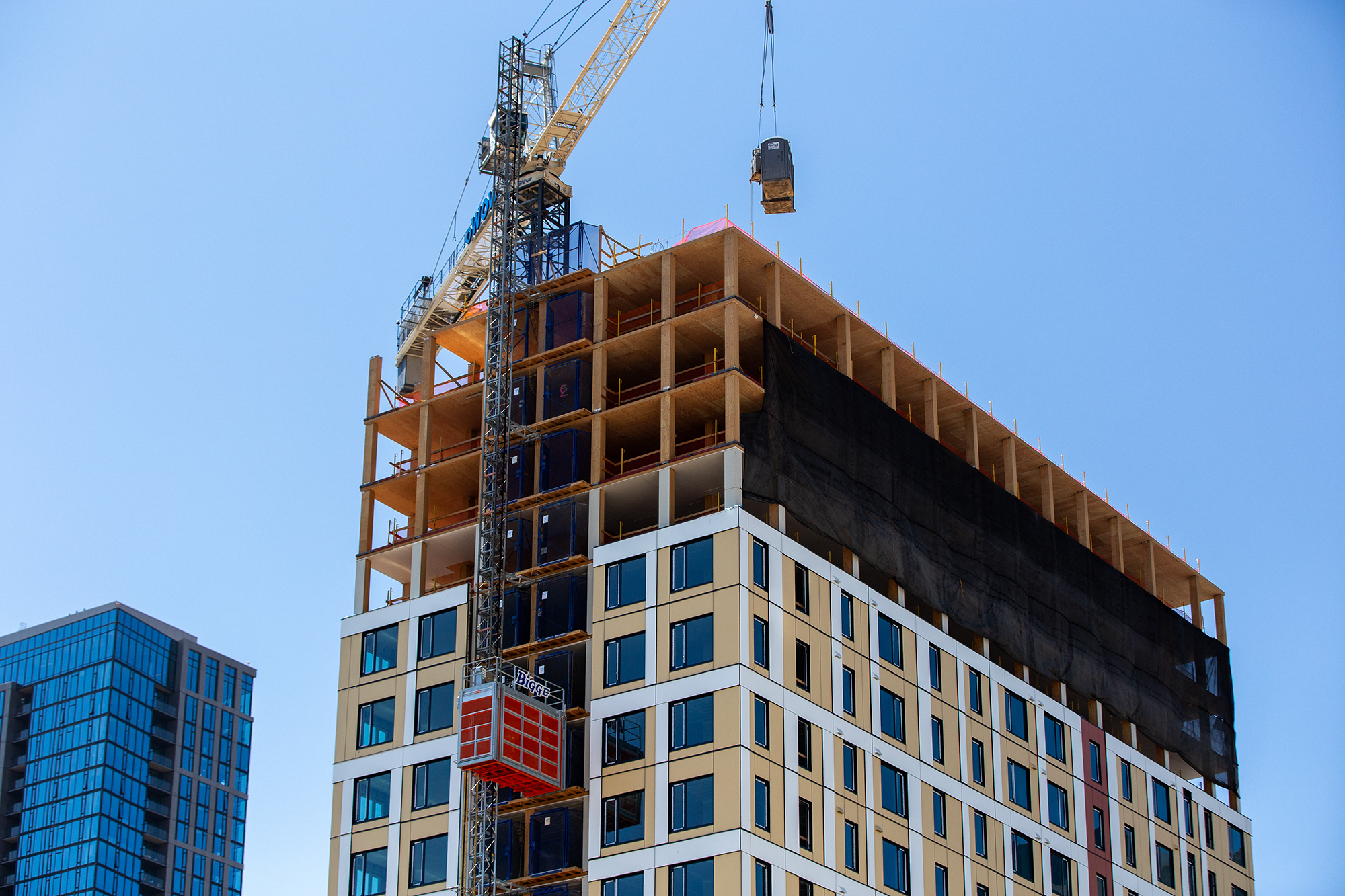 Construction of what will be one of the largest mass timber towers in the world at 1510 Webster St. in downtown Oakland on Aug. 7, 2023. Of the 222 units 35 are designated affordable housing for households earning around 80% of the Area Median Income. Photo by Semantha Norris, CalMatters