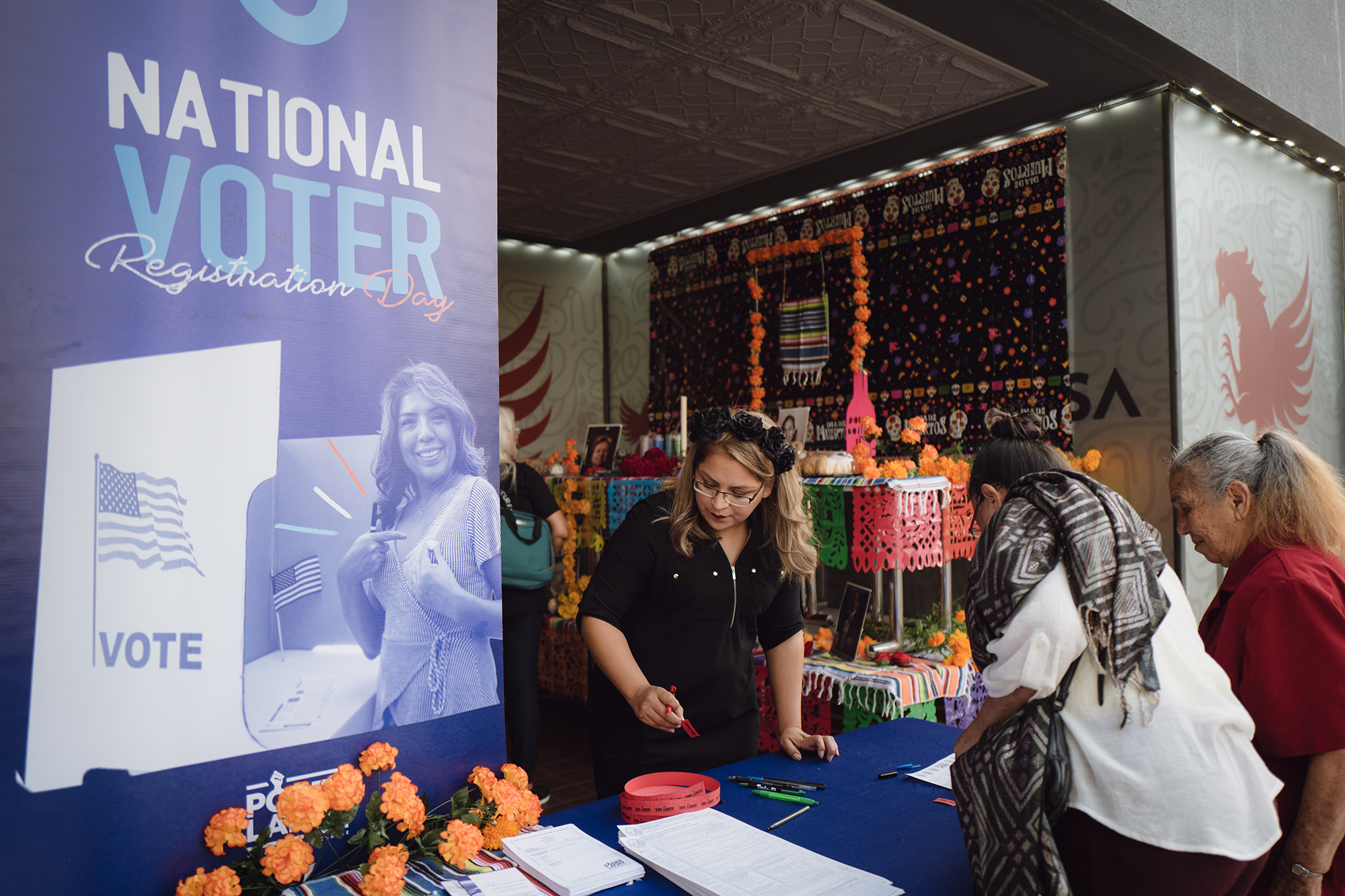 Local residents in Tulare County register at the Voter Registration event held in downtown Tulare on Nov. 1, 2023. Photo by Zaydee Sanchez for CalMatters