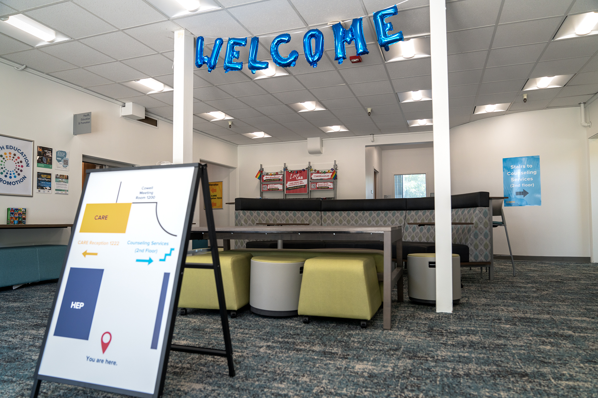 Balloons spell out "Welcome" at in the lobby of a general meeting area at the