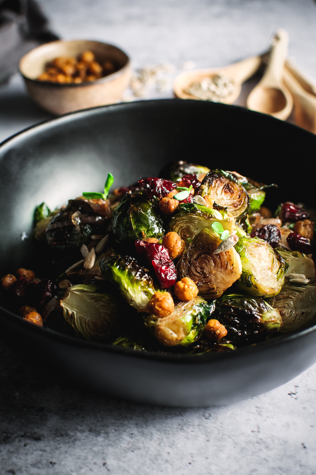 Chickpeas in black bowl with small bowl of crispy roasted chickpeas