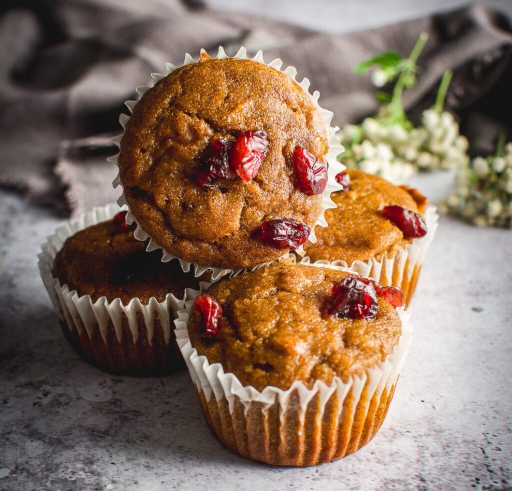 Healthy Grain-Free Cranberry Pumpkin Spice Muffins on table