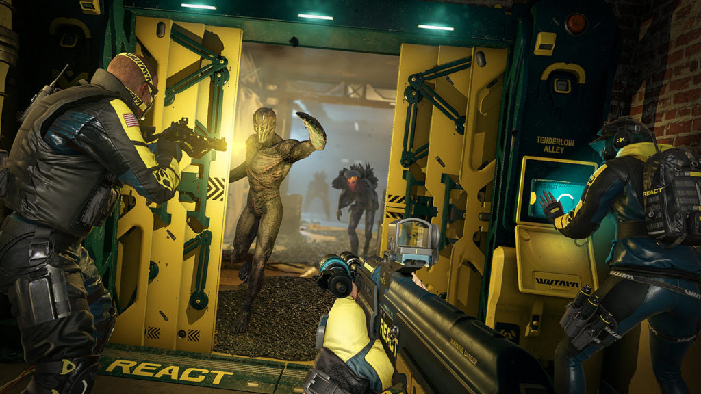 The player and another operative point their guns towards aliens advancing to a doorway, as a third operative works on a control panel to the right.