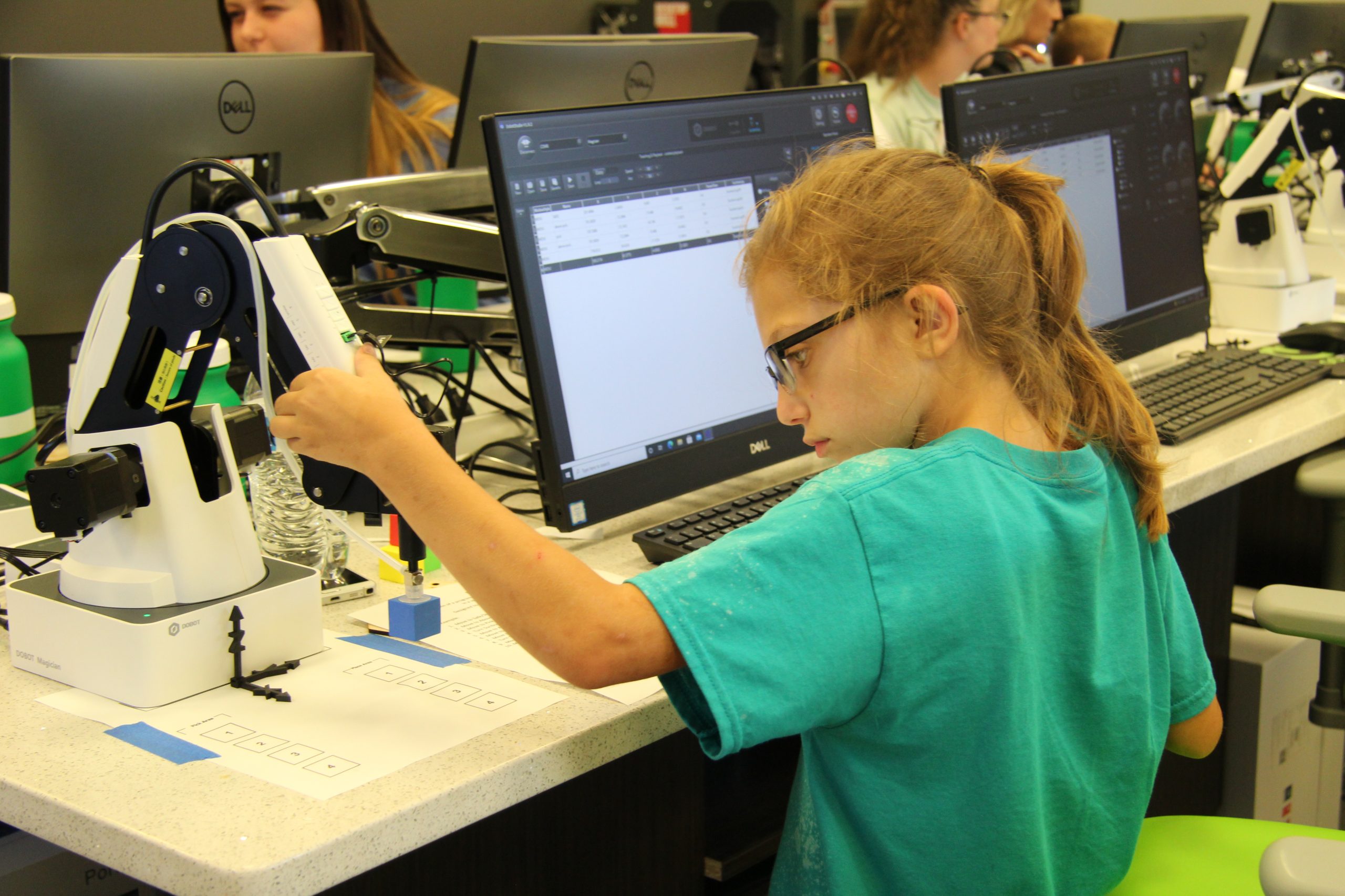 A middle school girl learns how to weld.