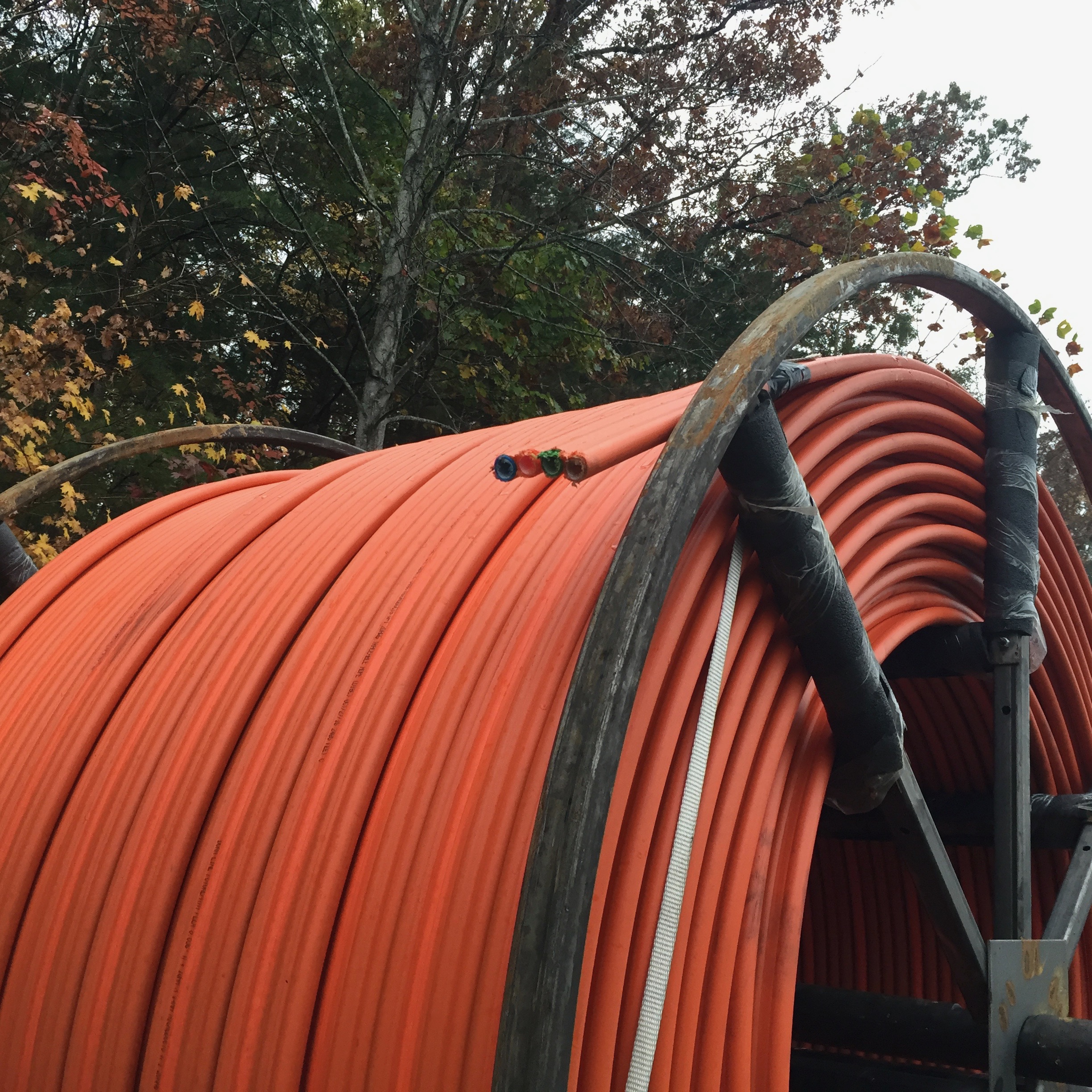 large roll of orange broadband fiber