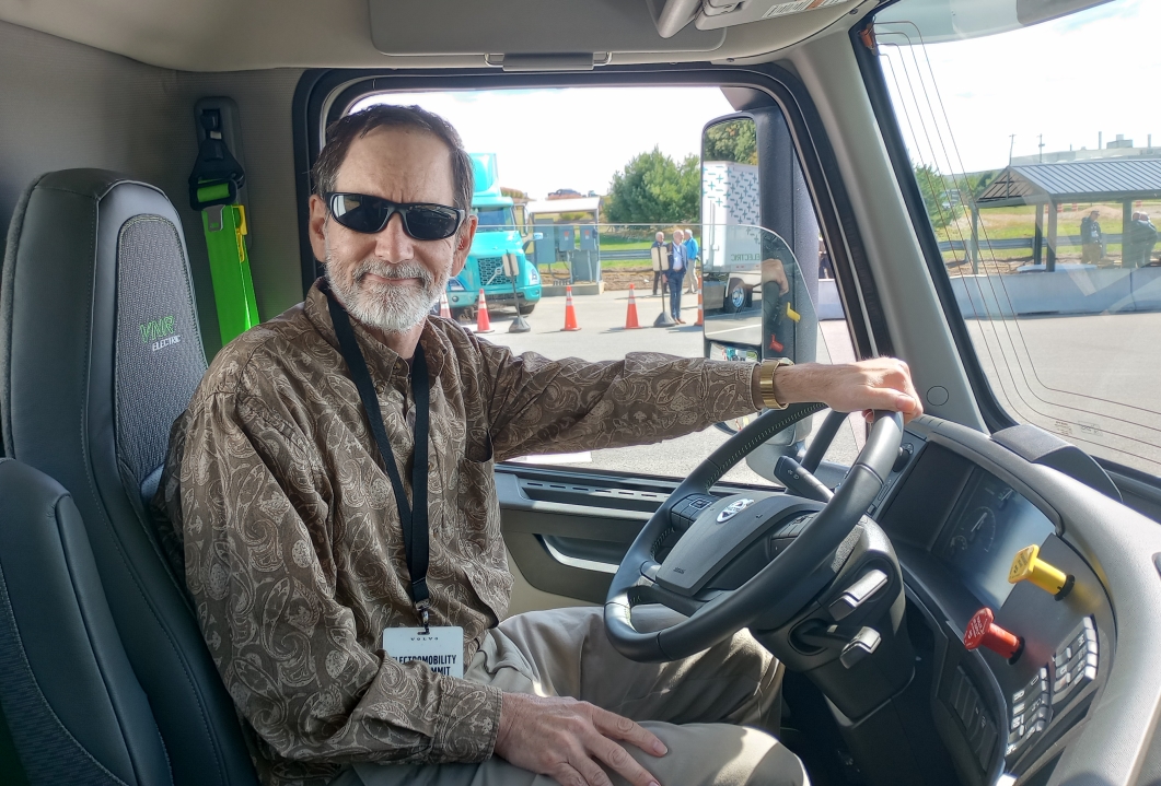 The writer at the wheel of an electric truck after having driven the track without crashing.
