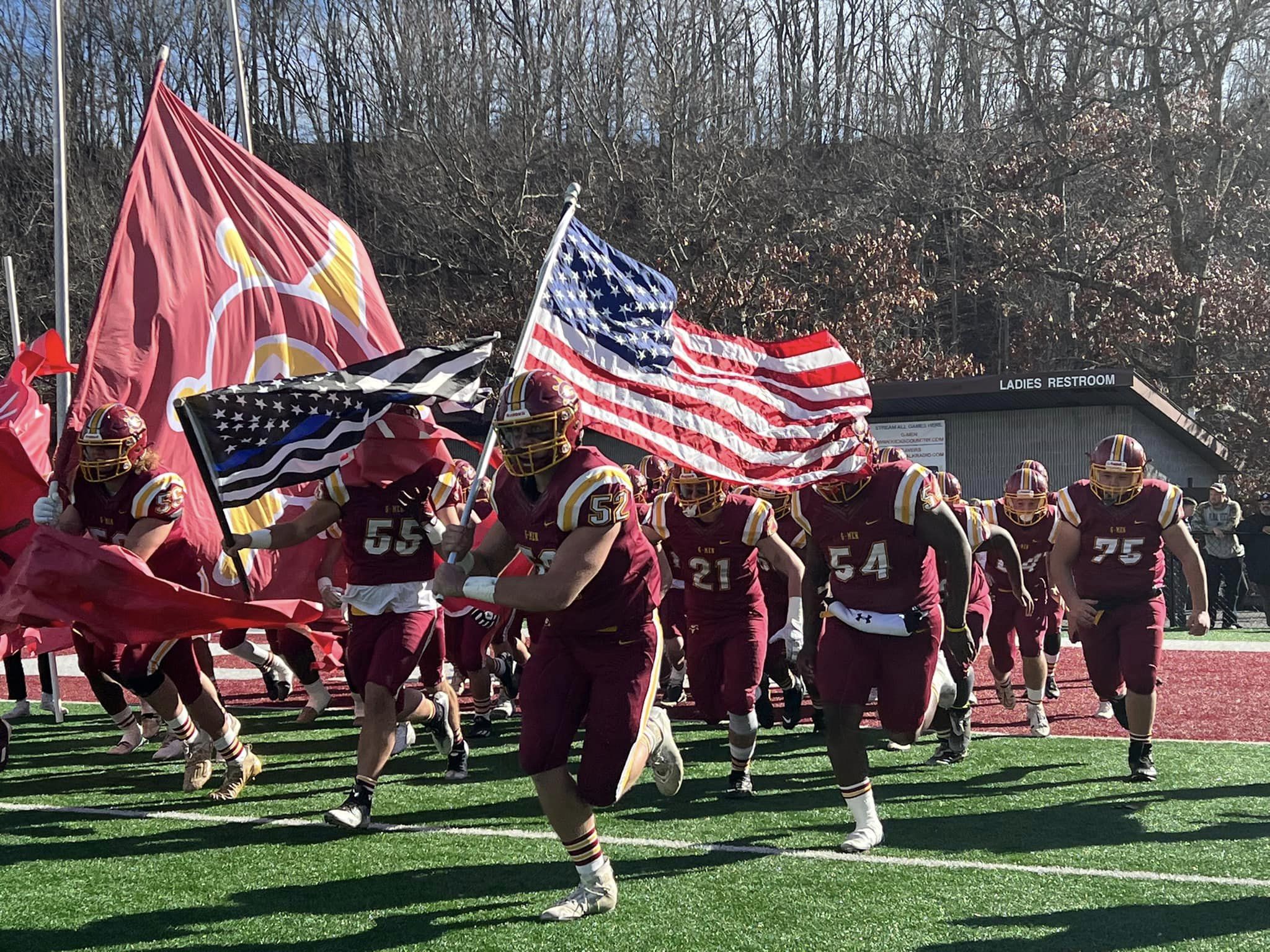 Cody Dolin leads the Graham G-Men onto the field during last month's playoff game with Ridgeview High School. Photo courtesy of Graham football.