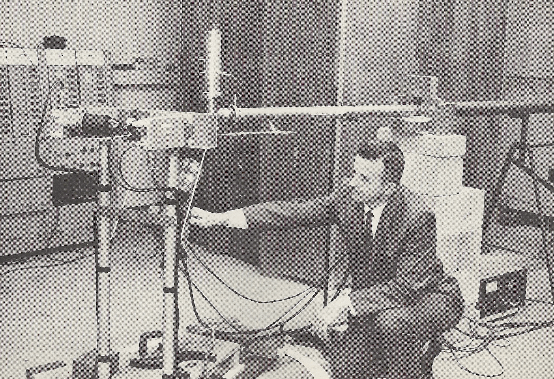 A man likely identified as John T. Rogers, a Virginia Tech Ph.D student, sets up a Cockroft-Walton accelerator for an experiment that used Virginia Tech's nuclear reactor. The photo was taken from professor Andrew Robeson’s “Report on Utilization of Nuclear Materials on Loan from U.S. Atomic Energy Commission” published in December 1962. Courtesy of Virginia Tech Special Collections