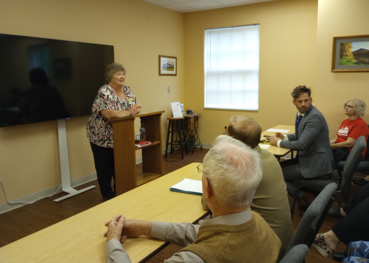 Bedford County general registrar Barbara Gunter (standing) ruled that Republican House of Delegates candidate Tim Griffin (at right, in gray suit) is a properly registered voter in Bedford County. Photo by Shannon Kelly.
