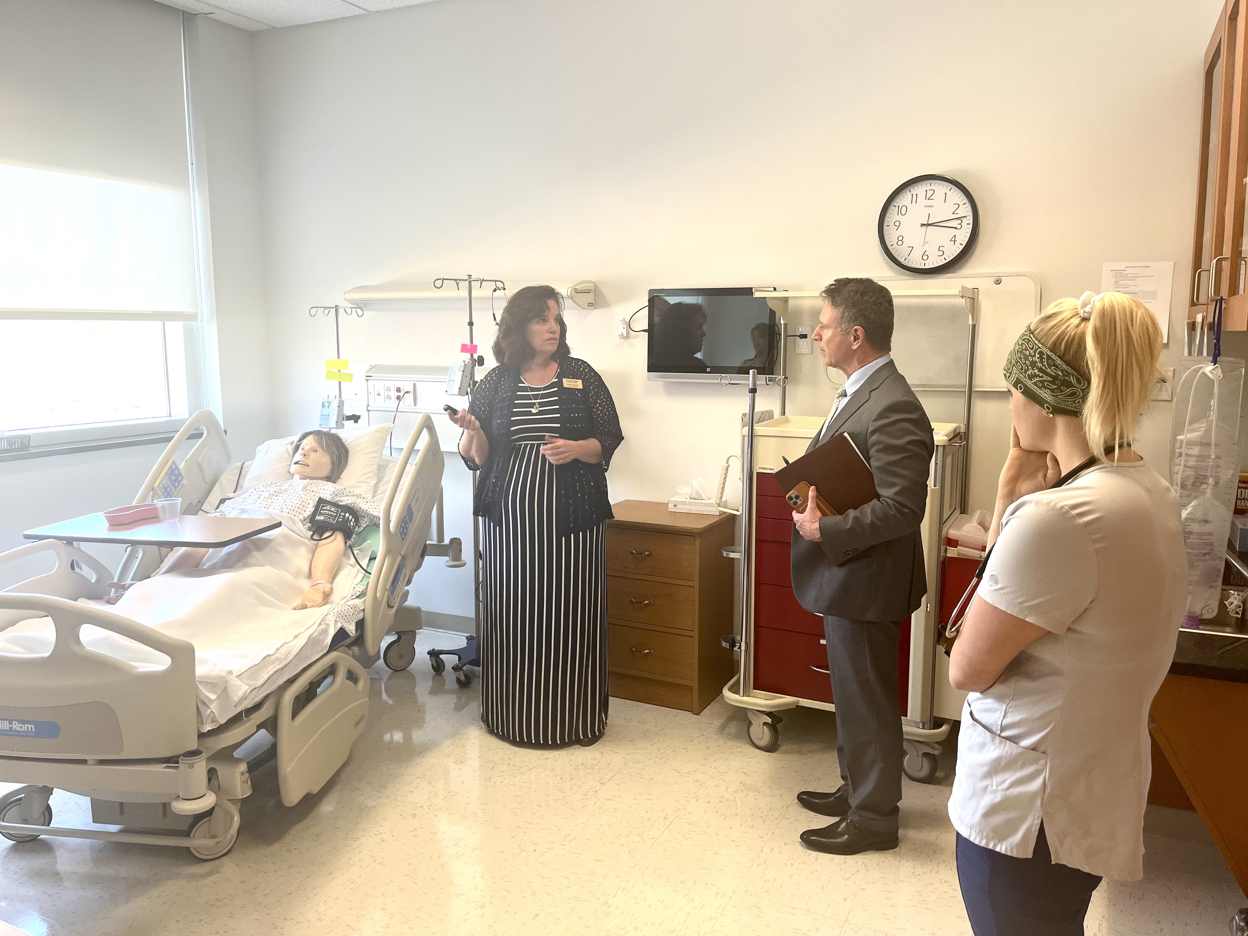 Director and Administrative Officer for Nursing Lauren Hayward (center) explains the features of a simulation lab to VCCS chancellor David Doré during a tour of Virginia Western Community College on April 4. Second-year nursing student Melissa Bittner (right) looks on. Photo by Lisa Rowan.