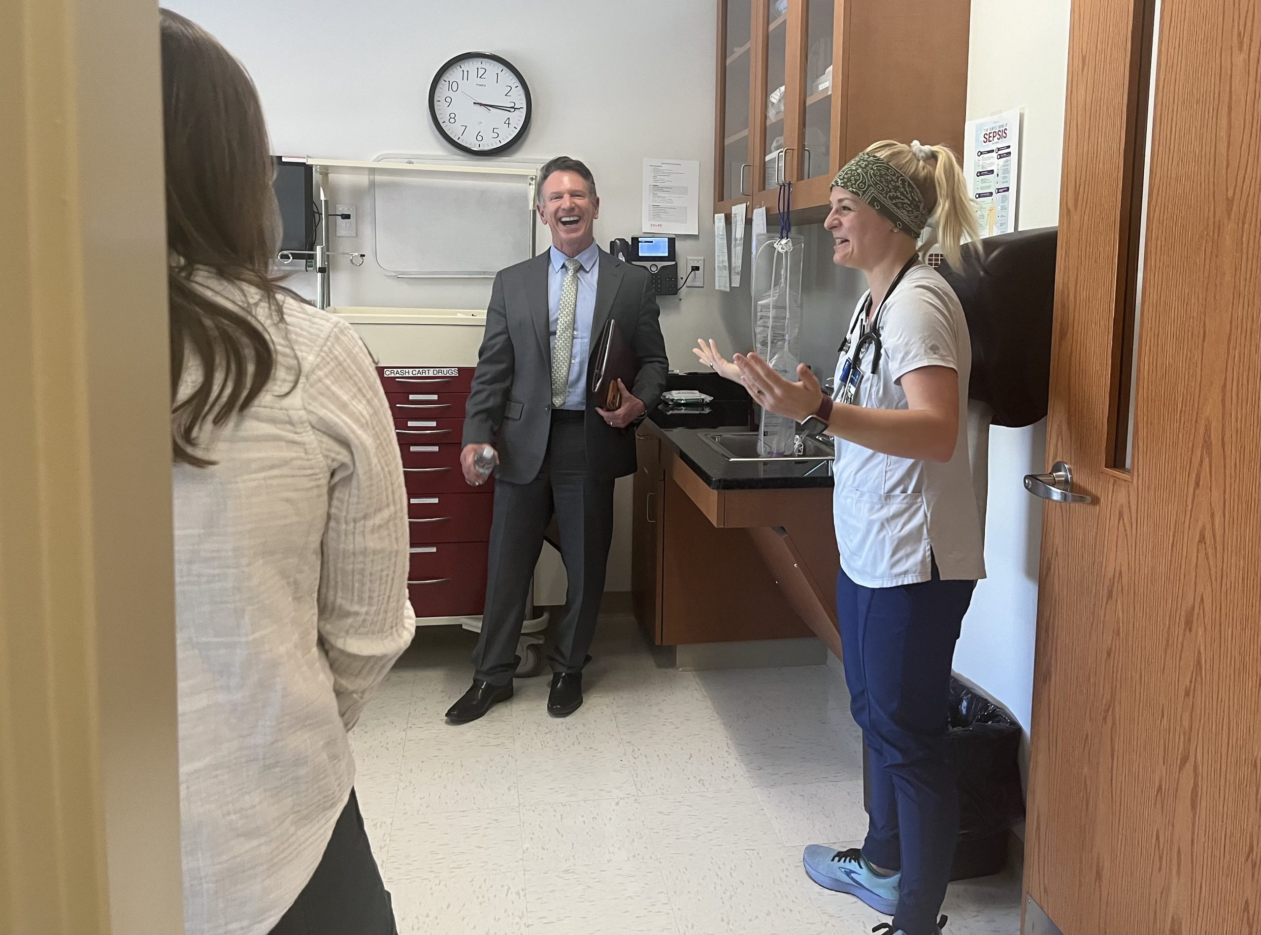 VCCS Chancellor David Doré (center) laughs with nursing students in a simulation lab during a tour of Virginia Western Community College on April 4. Second-year nursing student Melissa Bittner (right) graduates in May and has already received a job offer from Carilion Roanoke Memorial Hospital’s 8 Mountain Medical ICU. Photo by Lisa Rowan.