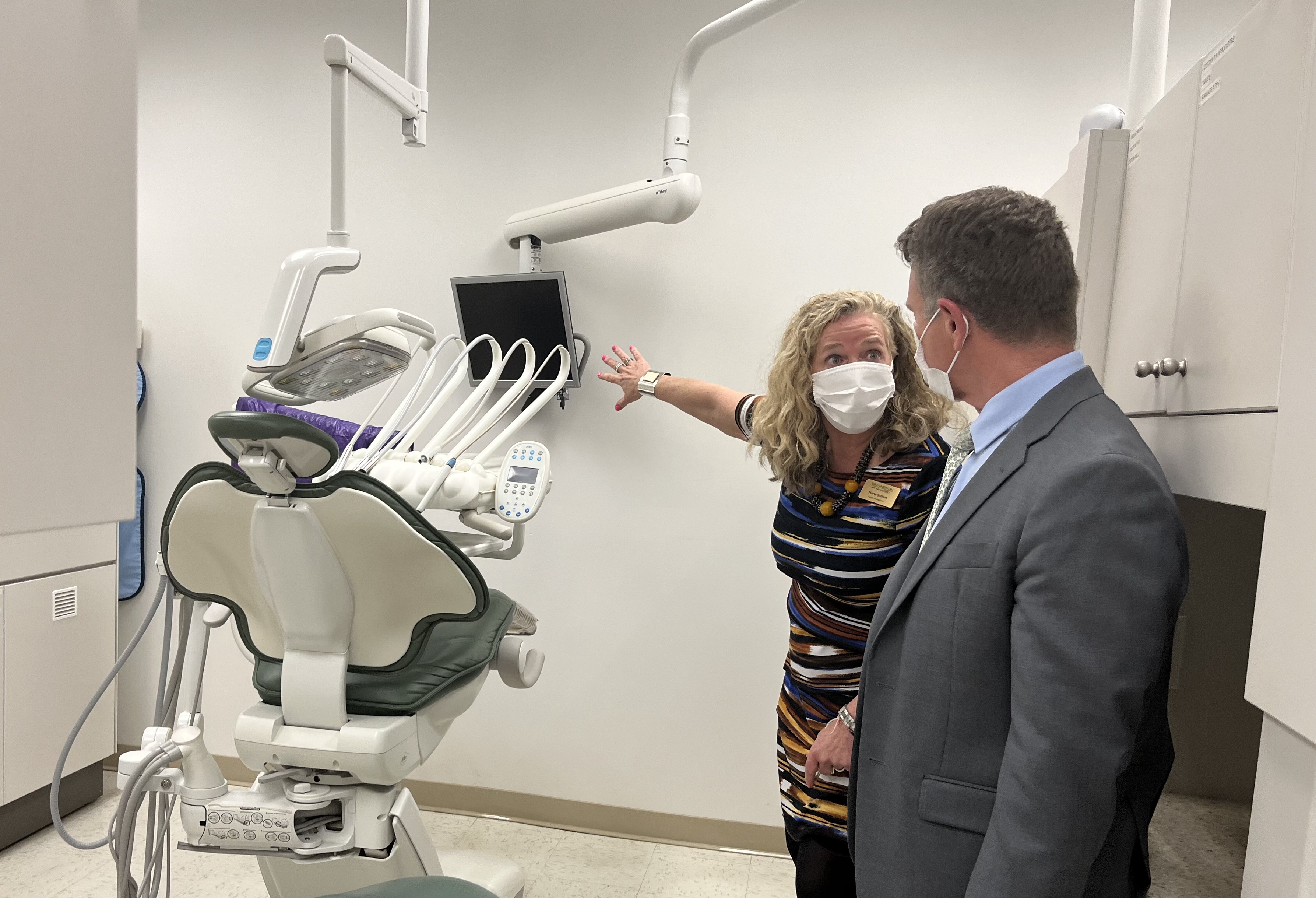 Marty Sullivan, dean of health professions, shows VCCS Chancellor David Doré (right) a treatment bay inside the school’s dental hygiene clinic during a tour of Virginia Western Community College on April 4. Photo by Lisa Rowan.