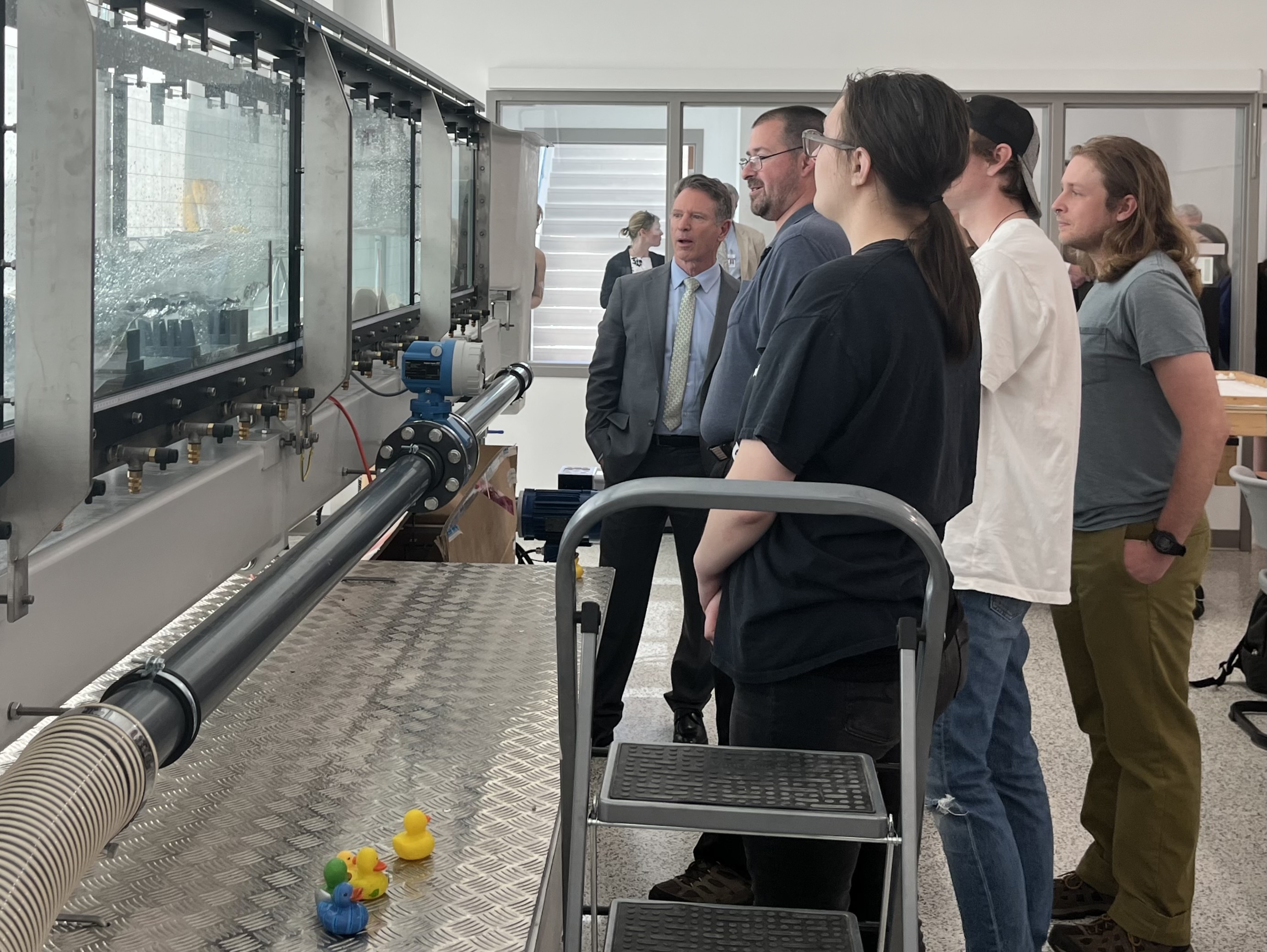 Virginia Community College System Chancellor David Doré (far center) views a 24-foot water flume used by students and instructors (right) in the STEM building during a tour of Virginia Western Community College on April 4. Photo by Lisa Rowan.
