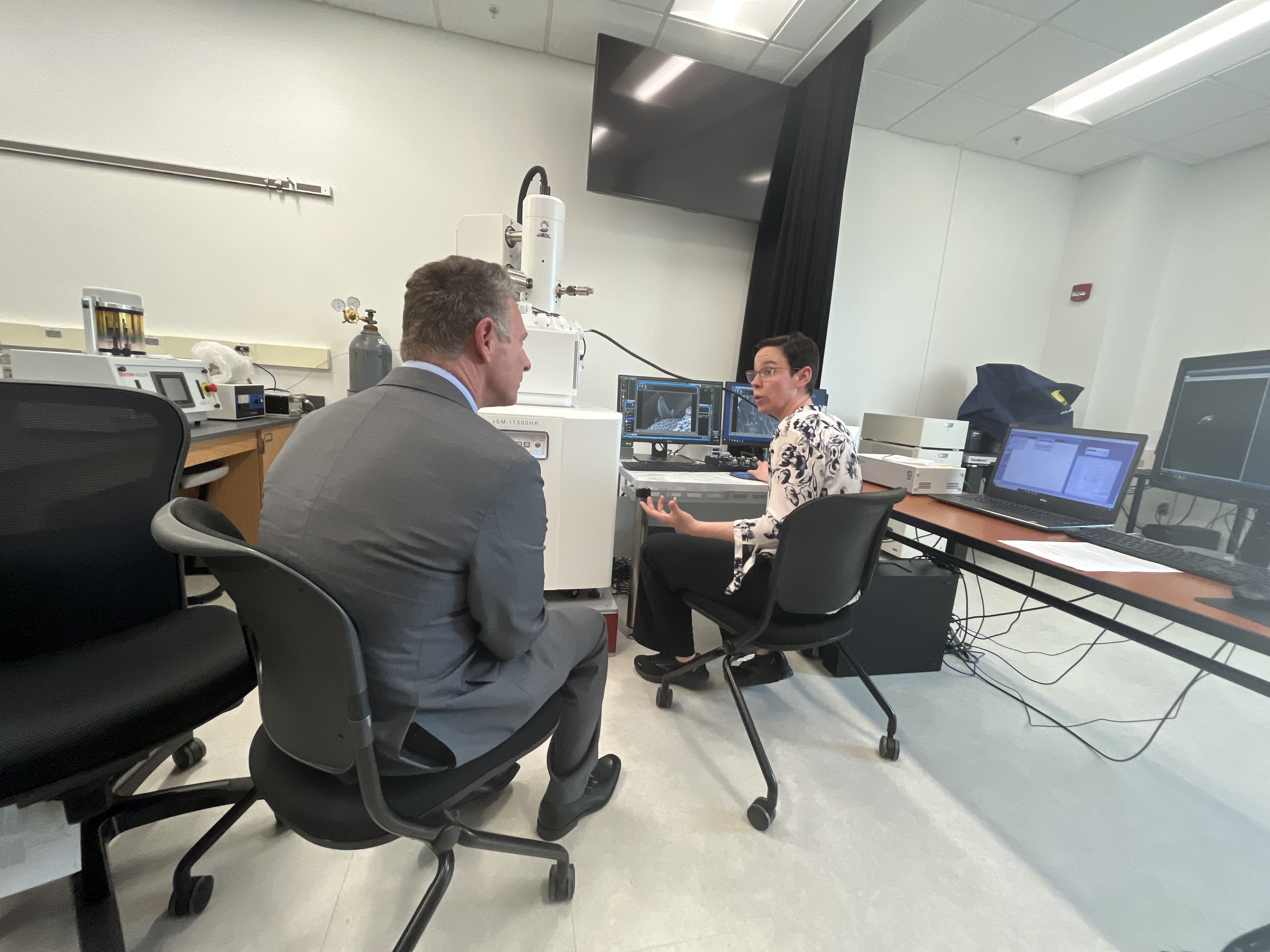 Virginia Community College System Chancellor David Doré (left) looks at images from a scanning electron microscope with Heather Lindberg, biology professor and director of the biotechnology degree program, during a tour of Virginia Western Community College on April 4. Photo by Lisa Rowan.