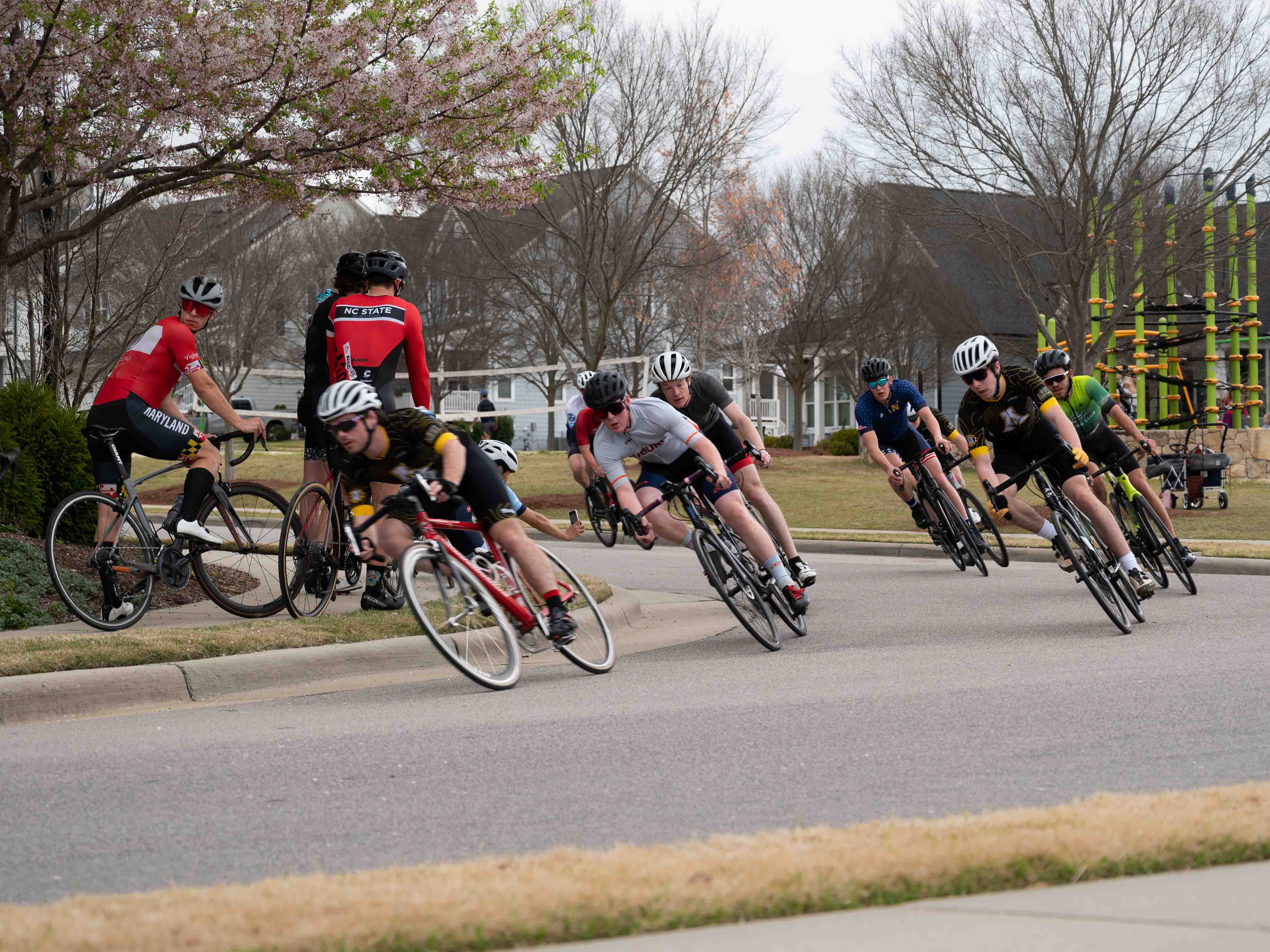 Collegiate criterium racers round a corner at the Chapel Hill Cycling Classic. Photo by Chad Braby
