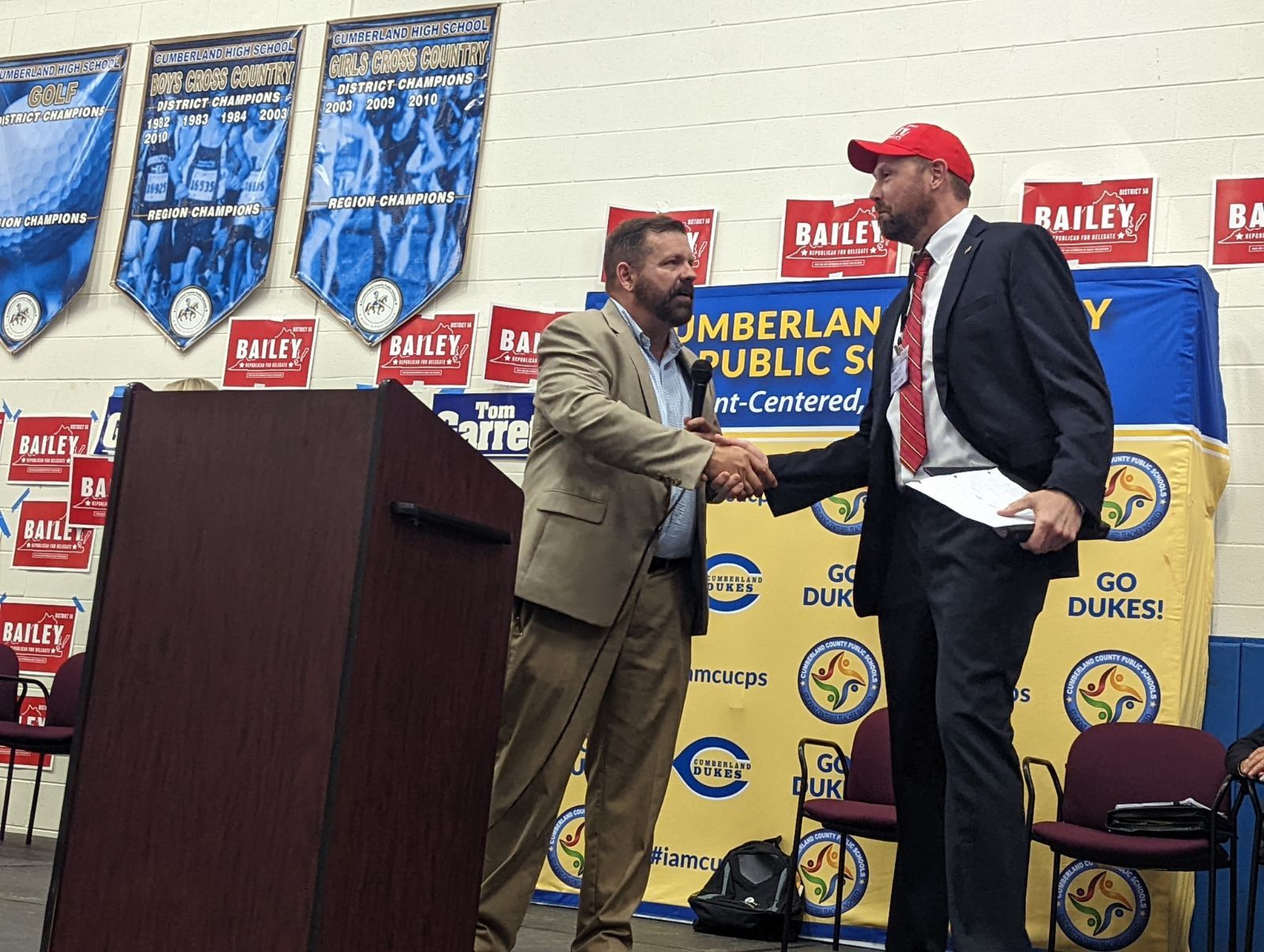 Former U.S. Rep. Tom Garrett, left, accepts congratulations from Kevin Bailey. Photo by Rachel Mahoney.