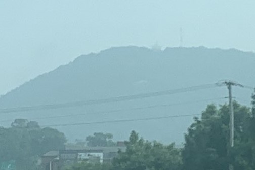 Roanoke's Mill Mountain is shrouded by haze, the landmark Star on top almost invisible, as seen only a few miles away alongside Interstate 581 on Wednesday afternoon, June 28. Canadian wildfire smoke swept into the region by northerly winds has caused a thick haze limiting visibilities and enhancing breathing difficulties especially in the medically vulnerable. Photo by Kevin Myatt