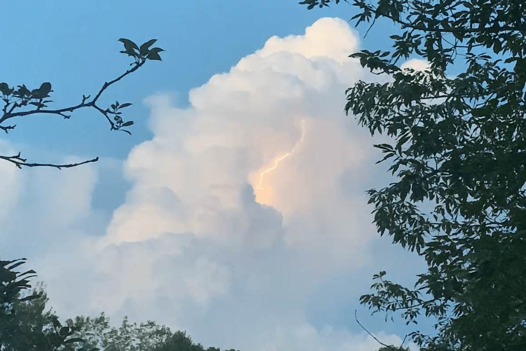 A bolt of lightning sparks within a cumulonimbus cloud over Bedford County, as seen from southern Roanoke County. Photo by Kevin Myatt.