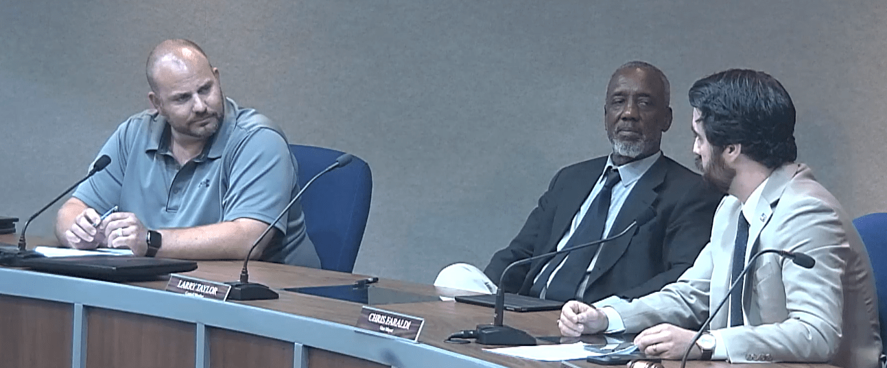 Vice Mayor Chris Faraldi, at right, confronts council member Marty Misjuns, at left. Between them is council member Larry Taylor. Screenshot of Lynchburg council meeting.