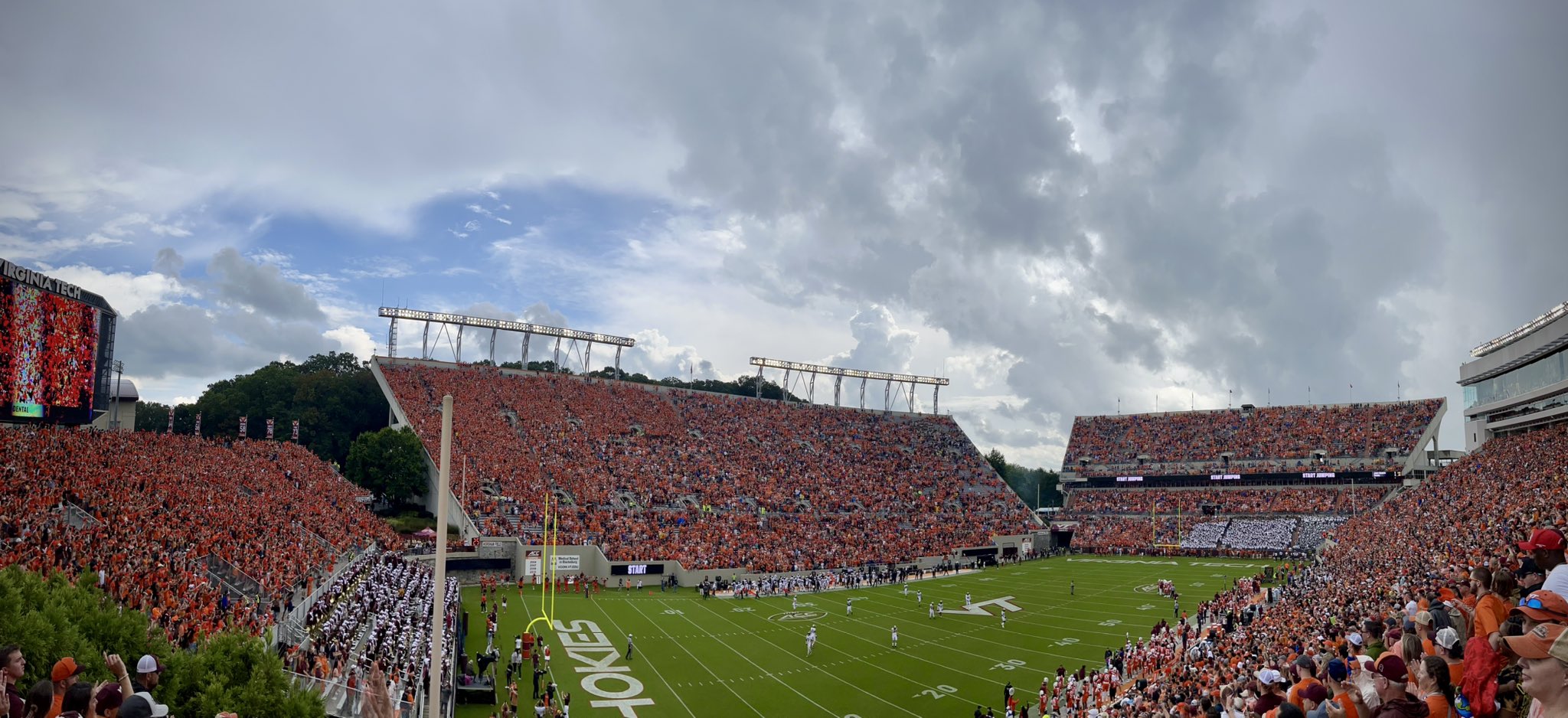 Storm clouds brew beyond Lane Stadium as Virginia Tech and Purdue players line up for the opening kickoff on Saturday. After a brief delay to start the game, another would be required several minutes later lasting over 5 hours as these towering cumulus clouds eventually developed into a powerful thunderstorm with historic rainfall, hail, gusty winds and fierce cloud-to-ground lightning. Courtesy of Al Jones.