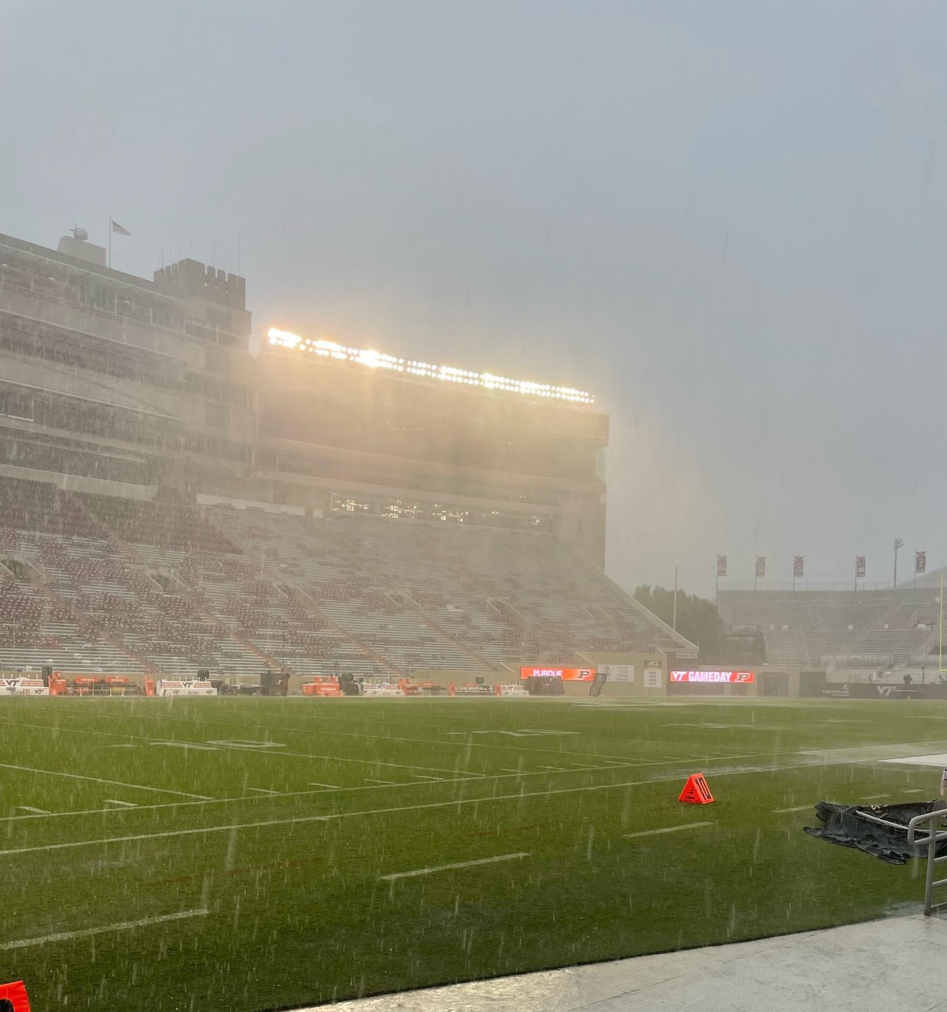 Rain and hail plummet down under the afternoon lights at Lane Stadium on Saturday. Courtesy of Mark Hollandsworth.