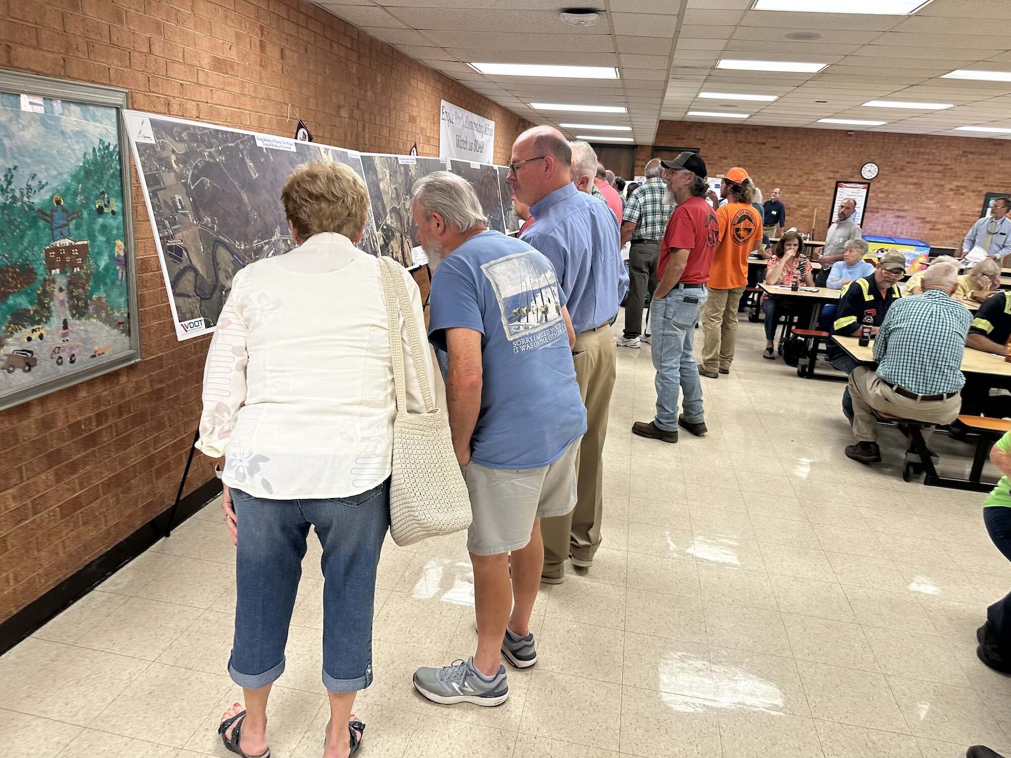 People at the Eagle Rock hearing study some of the maps. Photo by Mark Taylor.
