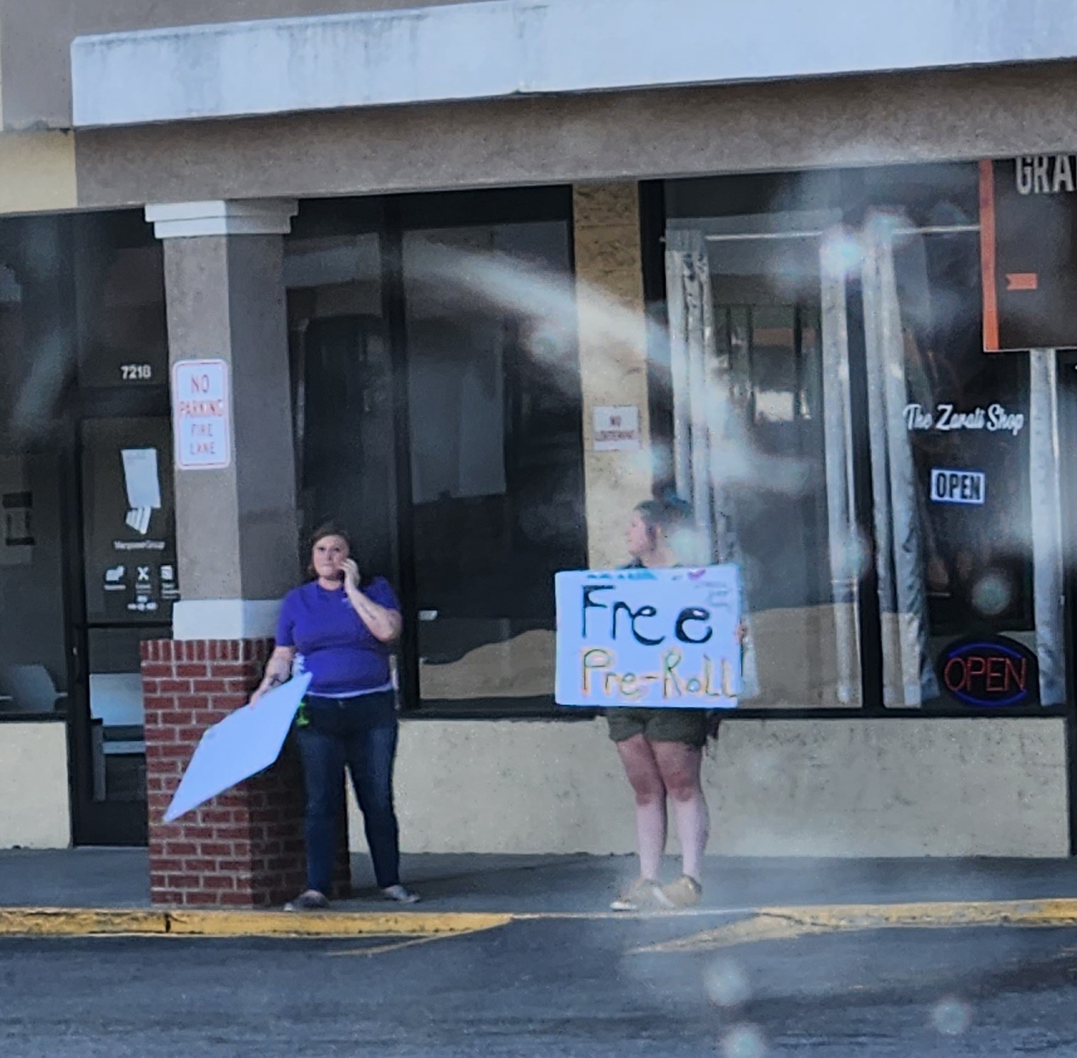 Clerks outside the Zarati Shop in July. Photo by Dwayne Yancey.