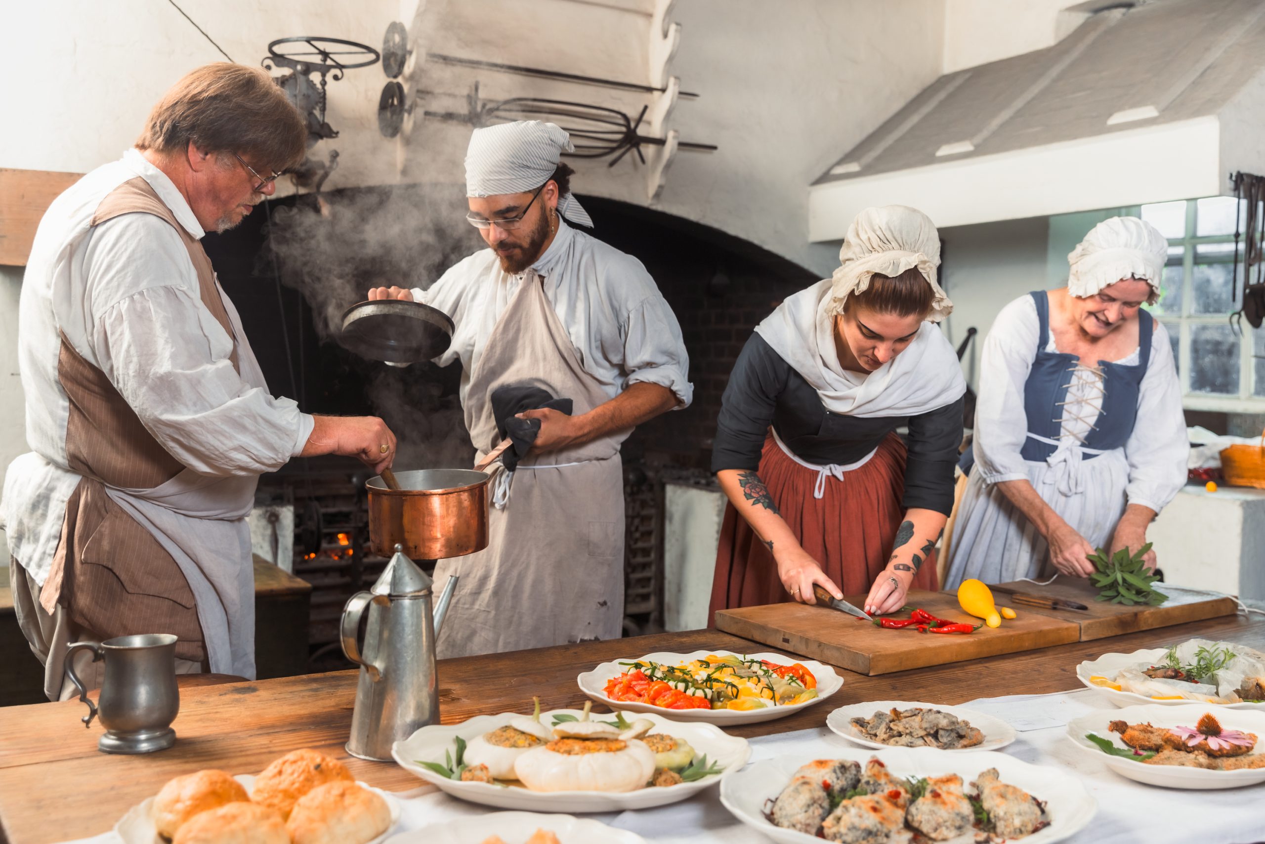 The Historic Foodways staff work in the Governor’s Palace Kitchen. Pictured (from left) are: Master Frank Clark, Apprentice Dominek Marsh, Apprentice Abbey Shoaf and Journeywoman Barbara Scherer. Photo by Brendan Sostak. Courtesy of Colonial Williamsburg.