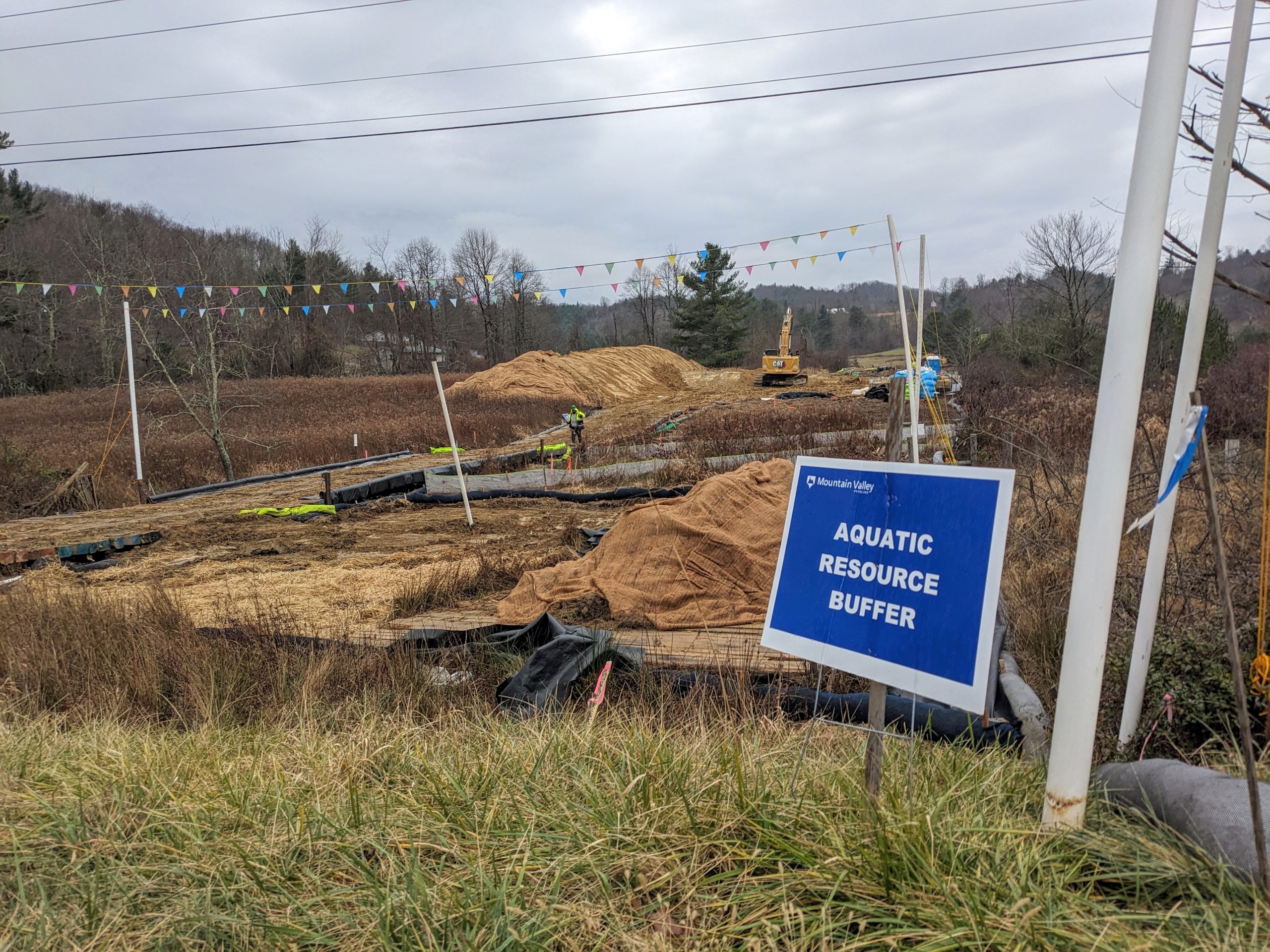 A bare-earth construction site on Bent Mountain, with a sign indicating it's a work area for the Mountain Valley Pipeline.