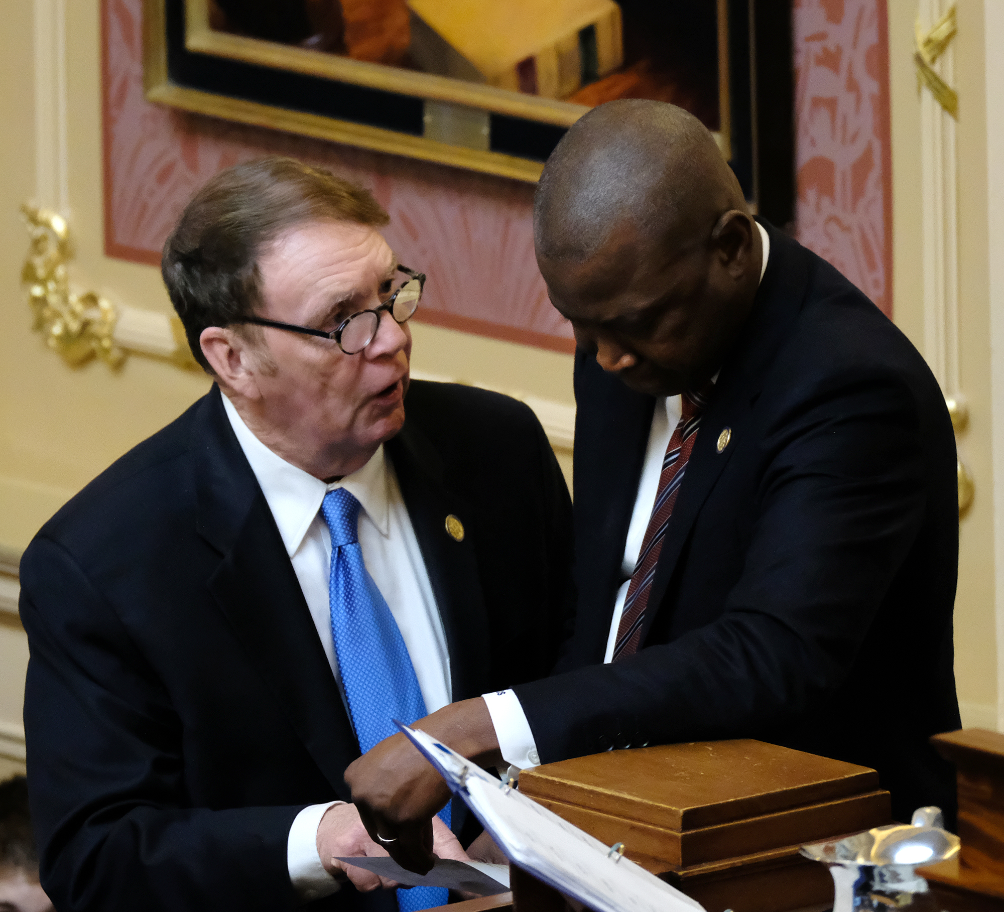 Del. Thomas C. "Tommy" Wright, Jr., R-Lunenburg, left, confers with House Speaker Don Scott, D-Portsmouth, right,  in the Virginia House of Delegates Wednesday, Jan. 10, 2024. Photo by Bob Brown.