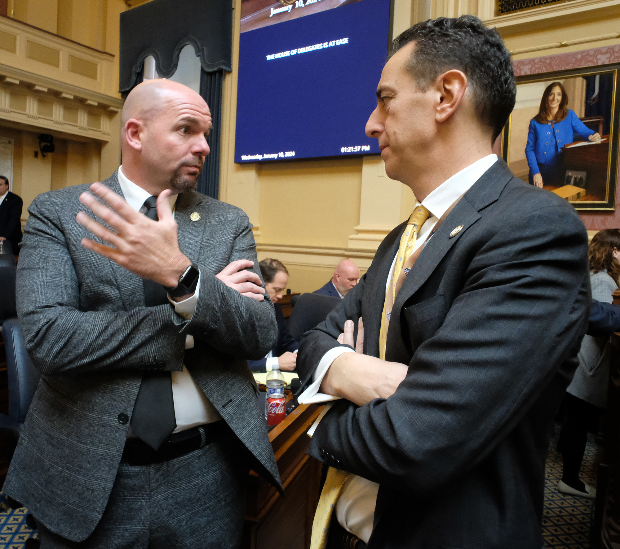Del. Jed Arnold, R-Wythe,  left, and Del. Marcus Simon, D-Fairfax, right, confer in the Virginia House of Delegates Wednesday, Jan. 10, 2024. Photo by Bob Brown.