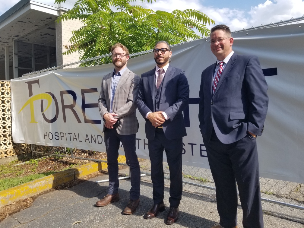 Foresight Health CEO Sameer Suhail, center, with Sean Adkins, who was then the director of economic development for Patrick County (left), and Joseph Hylak-Reinholtz, Foresight’s chief operations officer, in 2022.