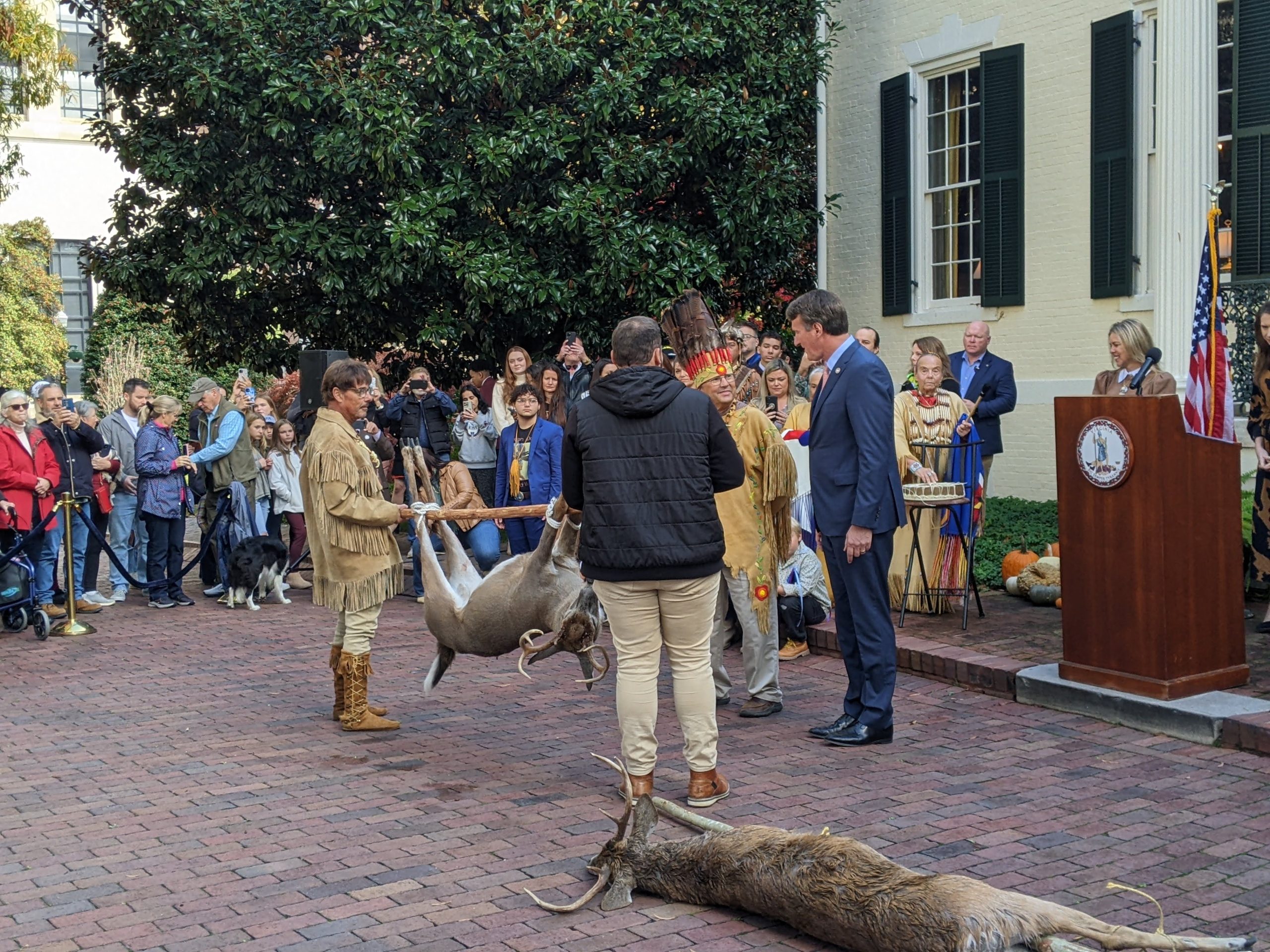 Gov. Glenn Youngkin speaks with Chief Mark Fallingstar Custalow as members of the Mattaponi Indian Tribe present a gift of a white-tailed deer for the 346th annual Tax Tribute Ceremony at the Executive Mansion in Richmond in November 2023. Photo by Ben Swensen.