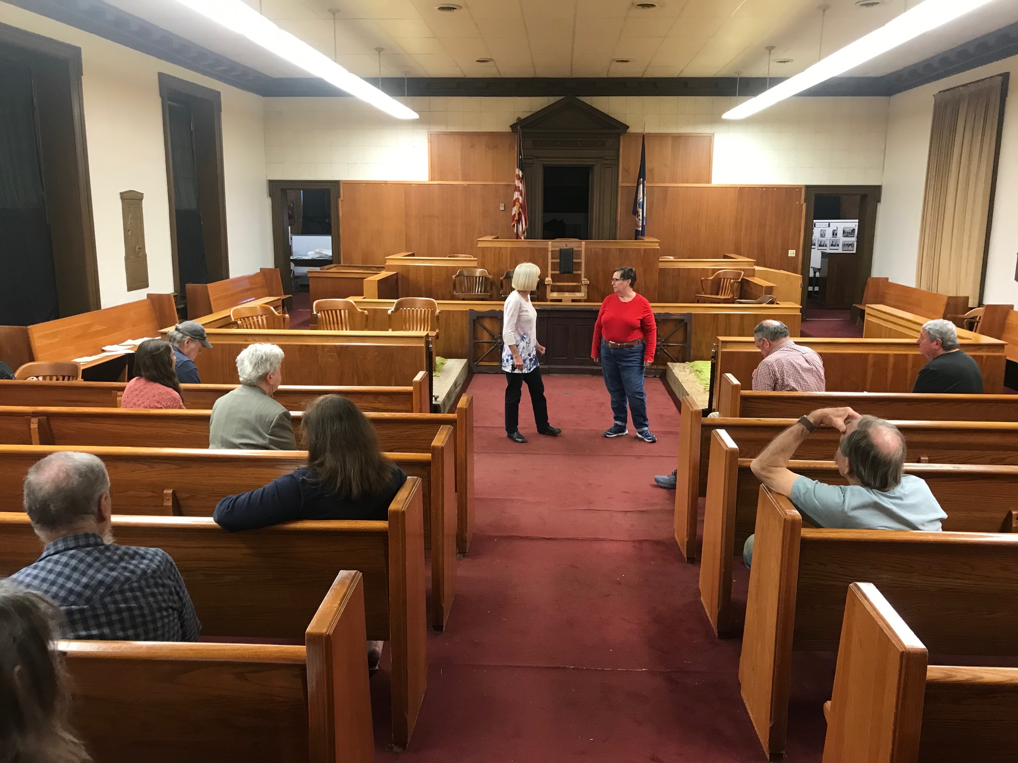 Actors rehearse a play in a courtroom.