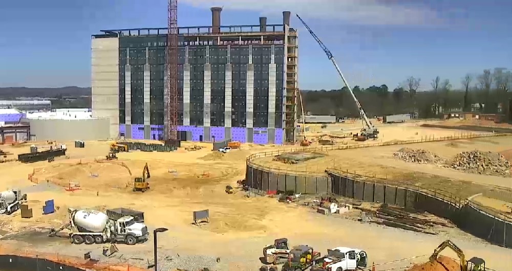 Multi-story hotel tower being built on a large construction site