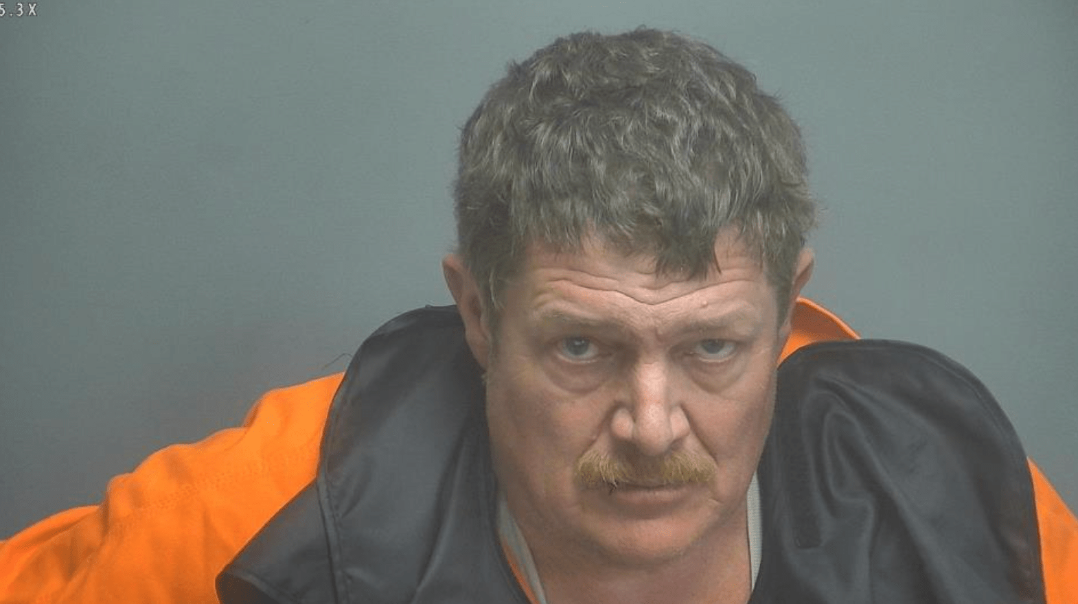 A man in a mugshot.