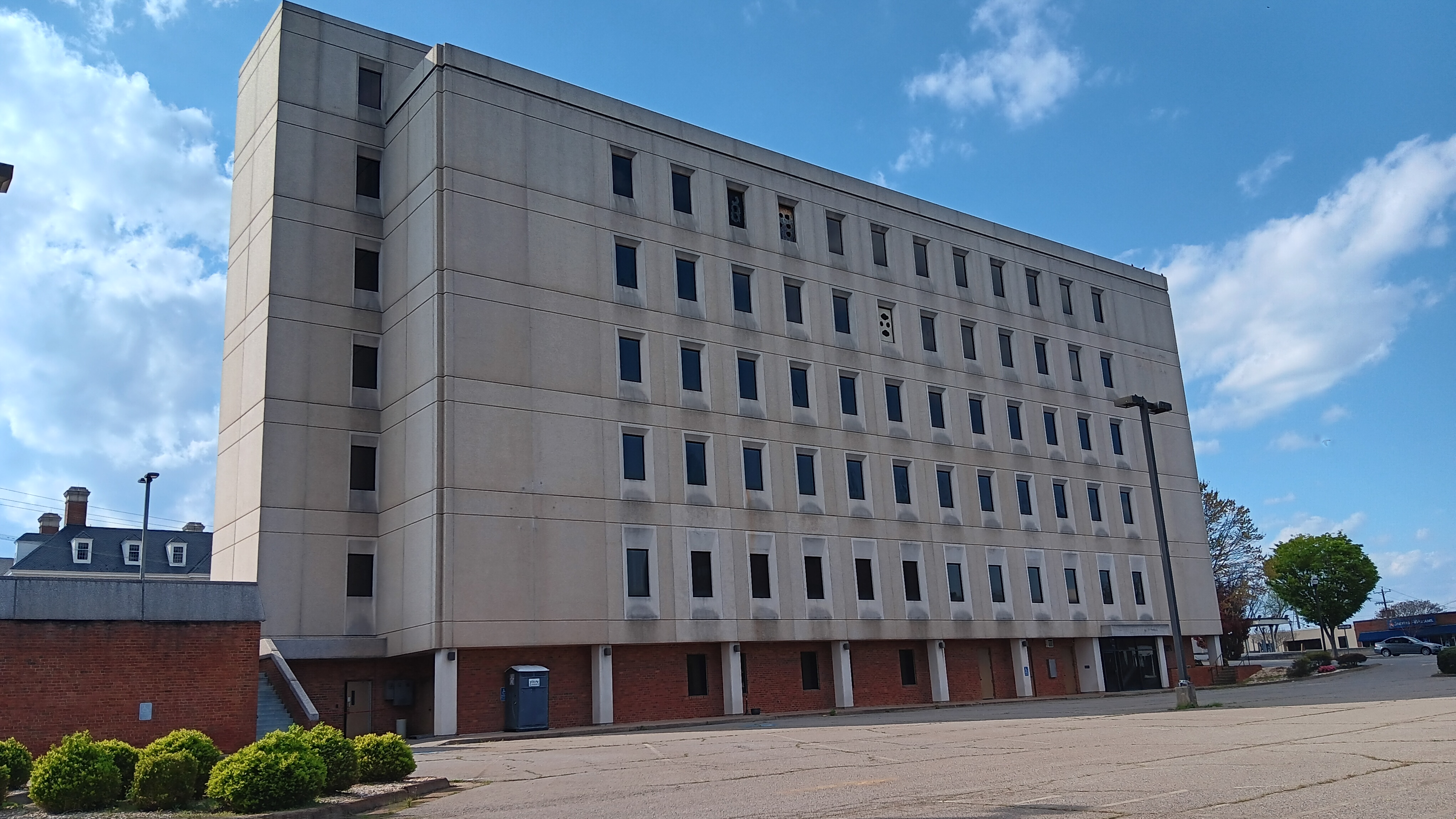 A six-story white brick building.