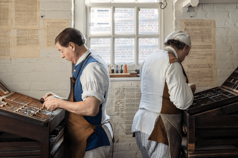 Re-enactors at Colonial Williamsburg show how a newspaper in colonial Virginia was assembled. Courtesy of Colonial Williamsburg Foundation.
