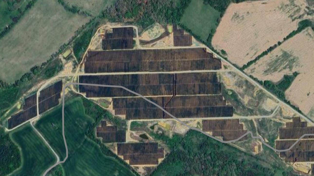 A satellite photo of rows of solar panels on a solar farm.