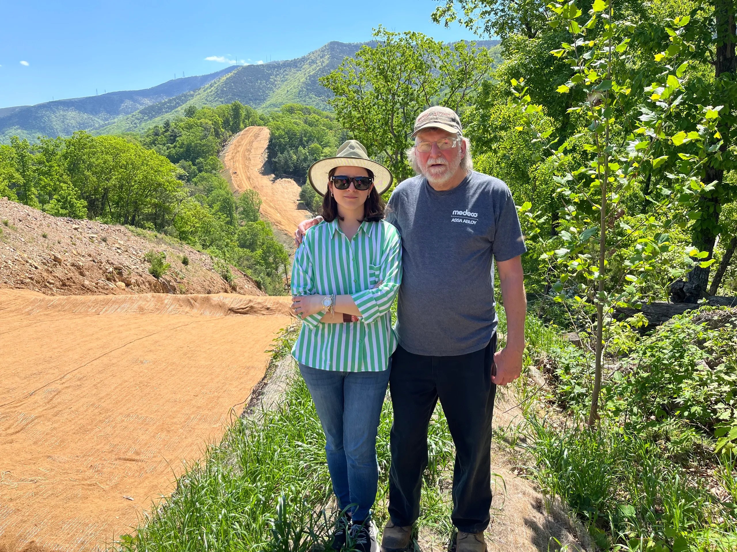 Attorney Mia Yugo and Montgomery County resident Cletus Bohon pose for a picture on land with a pipeline path running through it.