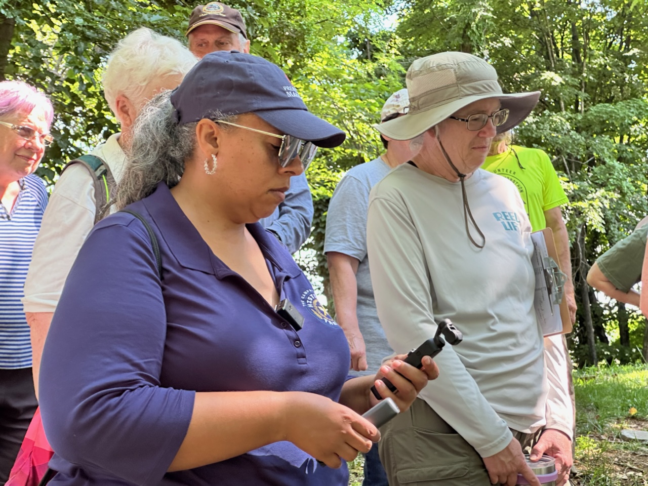 Kelly Pratt, ith Preservation Maryland’s Campaign for Historic Trades, stands in a group at the cemetery.