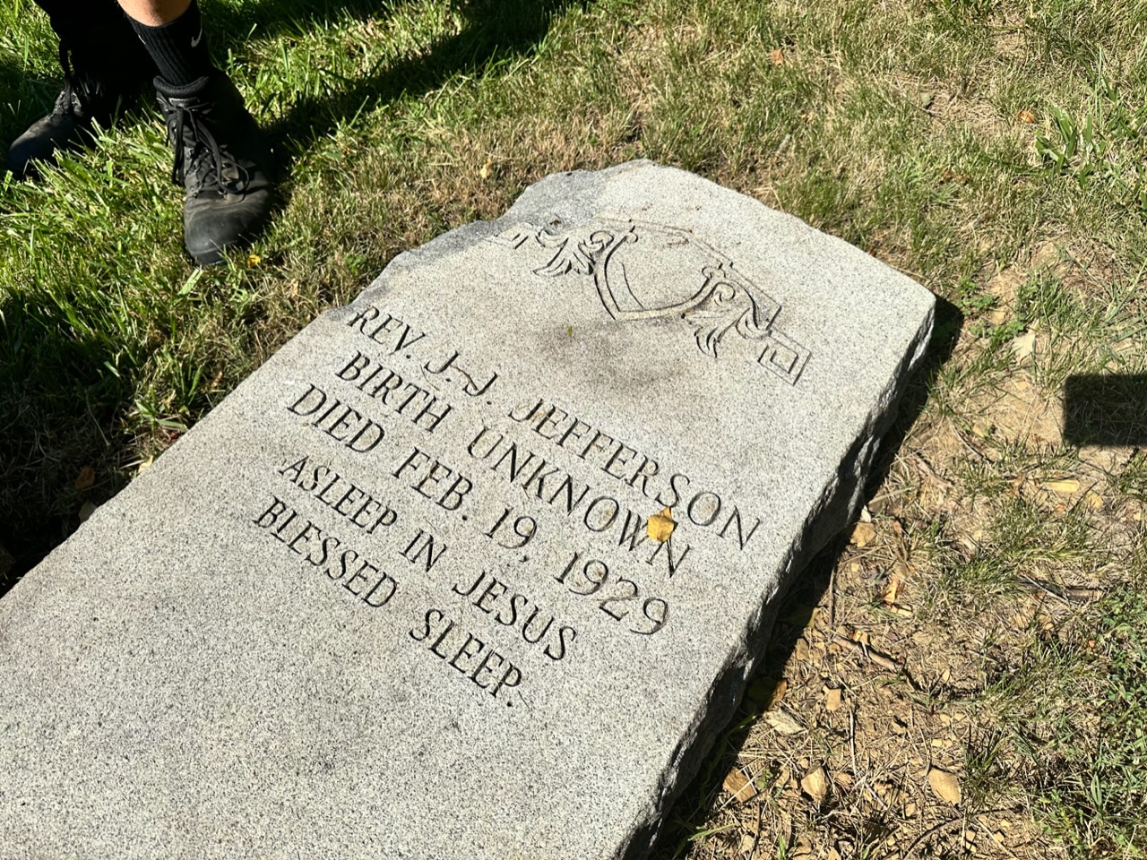 The tombstone of the Rev. J.J. Jefferson: "Birth unknown / Died Feb. 19, 1929 / Asleep in Jesus / Blessed Sleep."