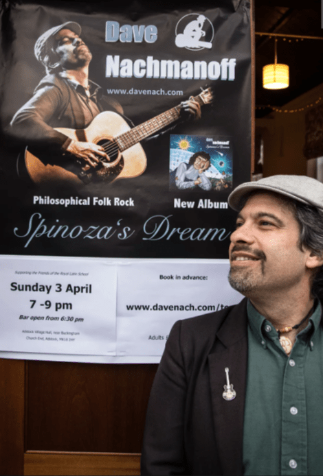 Dave Nachmanoff with one of his concert posters in Adstock, Great Britain. Courtesy of Nachmanoff.