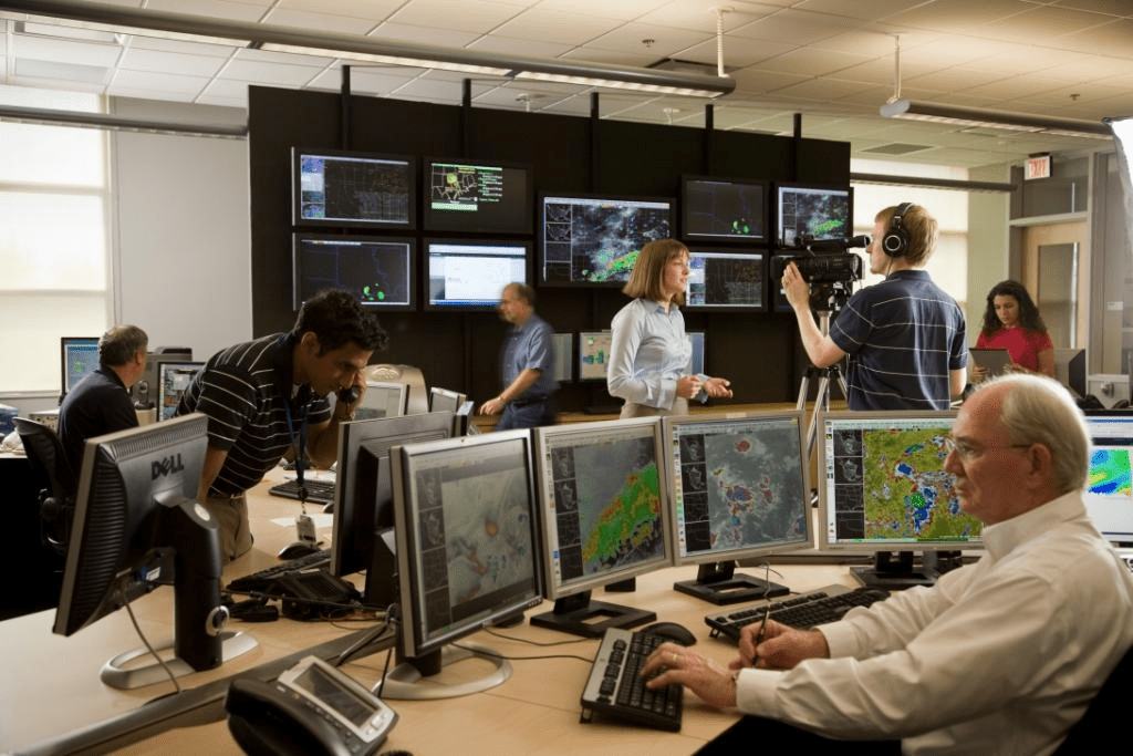  Forecasters pore over computer data to make weather forecasts, a task expected to become faster and more accurate with the application of artificial intelligence in coming years.  Courtesy of National Weather Service.