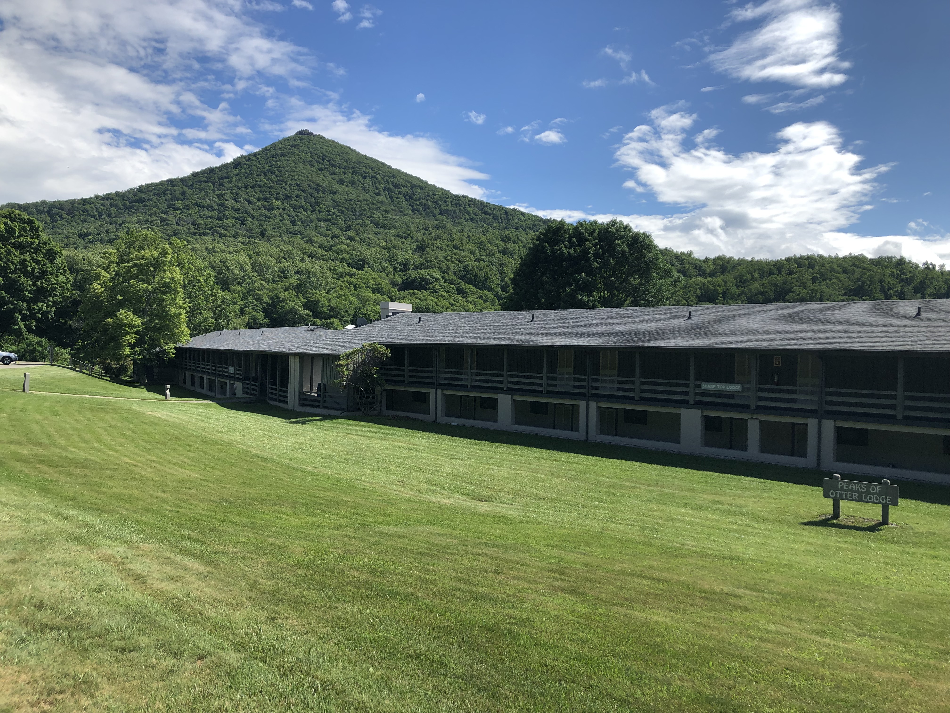A motel building at the Peaks of Otter Lodge stands in front of Sharp Top Mountain, in Bedford County.